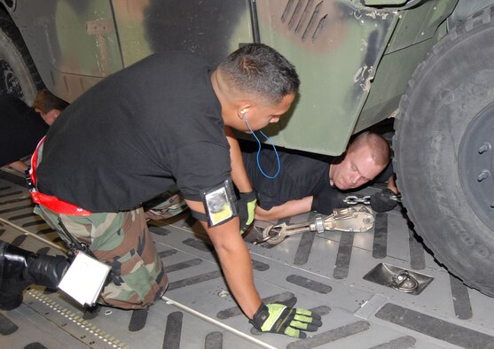 Members of the 3rd Aerial Port Squadron at Pope Air Force Base, N.C., tie down a Humvee that was deployed to Brownsville, Texas, Aug. 19 along with about 40 members of the 43rd Aeromedical Evacuation Squadron in preparation for Hurricane Dean relief efforts. (U.S. Air Force photo/Ed Drohan)