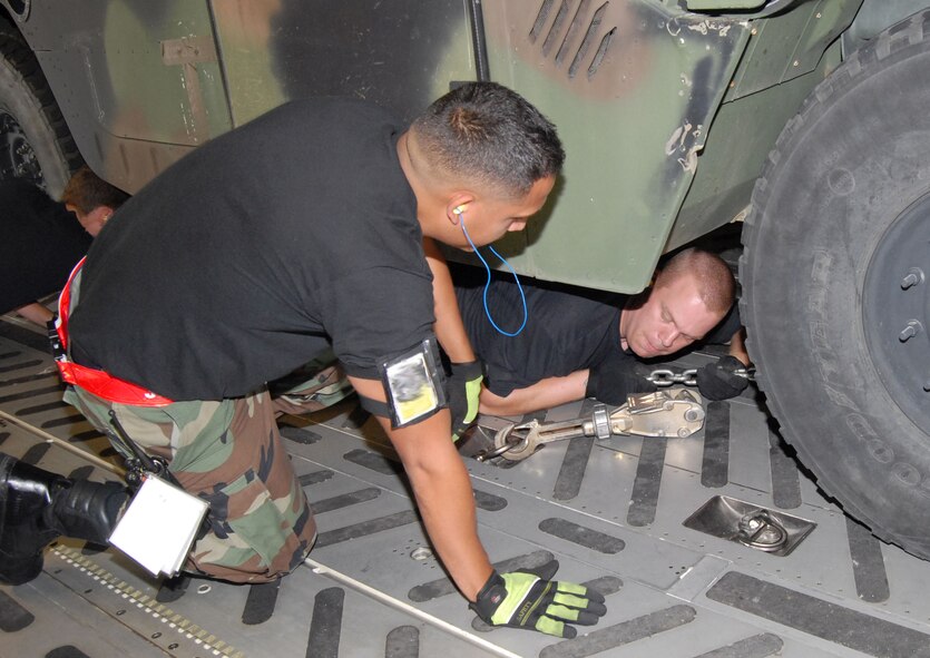 Members of the 3rd Aerial Port Squadron at Pope Air Force Base, N.C., tie down a Humvee that was deployed to Brownsville, Texas, Aug. 19 along with about 40 members of the 43rd Aeromedical Evacuation Squadron in preparation for Hurricane Dean relief efforts. (U.S. Air Force photo/Ed Drohan)