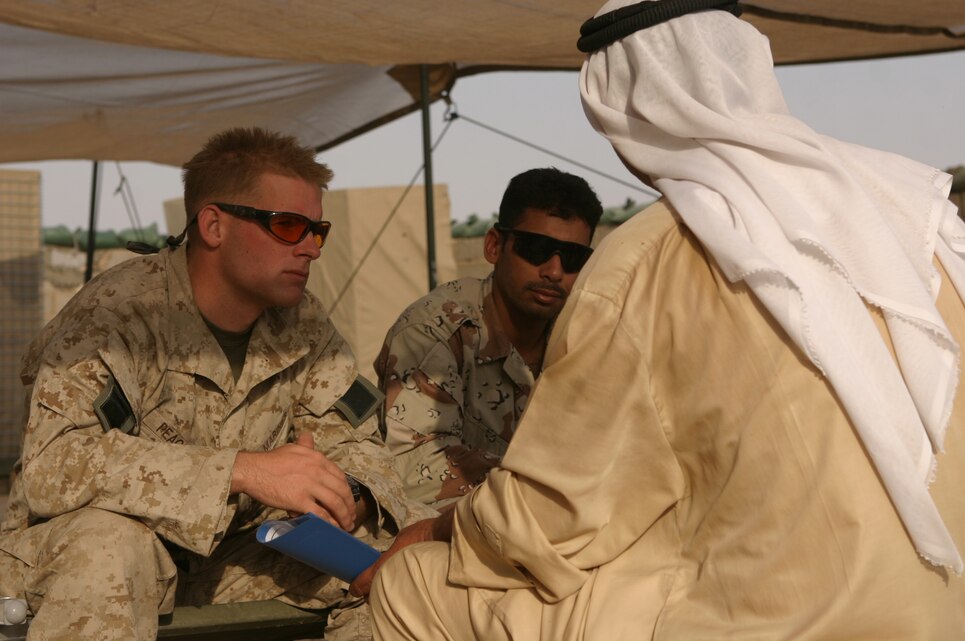 Listening intently, 2nd Lt. Phil Peacock, a platoon commander for Lima Company, BLT 3/1, meets with a local man during an impromptu "walk up" visit to the platoon's patrol base. Peacock and his Marines have become accustomed to the visits, and although safety takes priority, the Marines enjoy the opportunity to show the human side of counter insurgency operations. (Photo By Sgt. Andy Hurt/13th MEU)