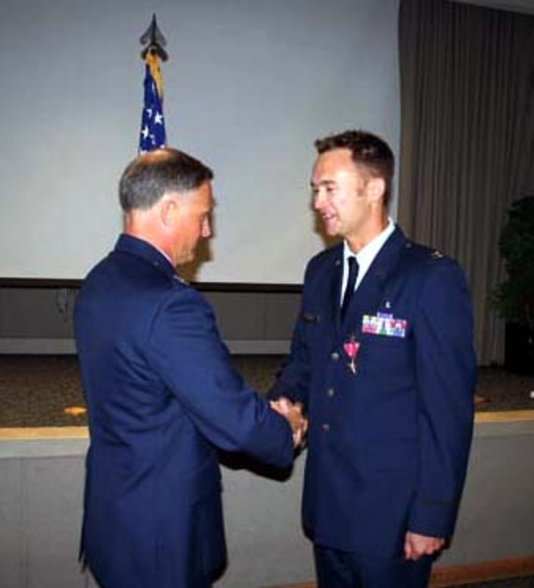 Col. Dennis Pannell (left), 1st Special Operations Group commander, congratules Capt. Kevin Fischer, 1st Special Operations Support Squadron, after receiving his Bronze Star for his actions in Iraq. Photo by Jamie Haig.