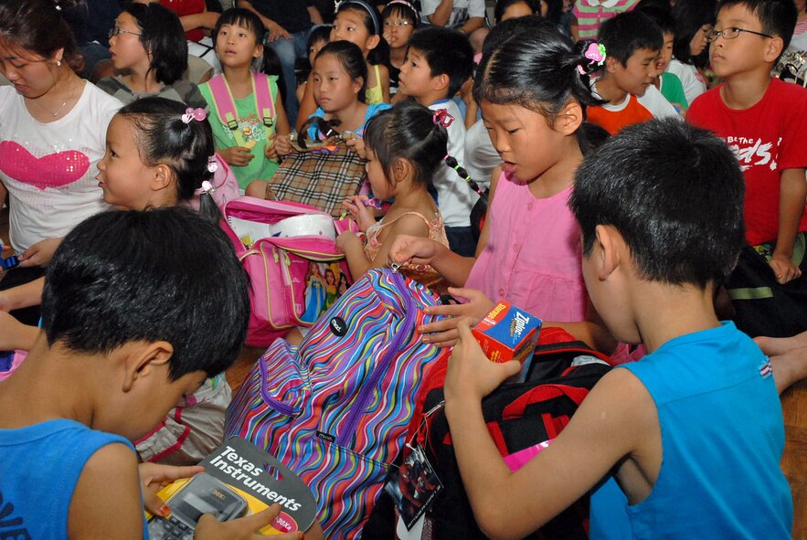 OSAN AIR BASE, Republic of Korea --  Children at the Ae-Hyang Won orphanage pick through new backpacks they recieved from Soldiers of the Headquarters and Headquarters Battery, 35th Air Defense Artillery Brigade on Aug. 18. (U.S. Army photo by Pfc. Gretchen N. Goodrich)