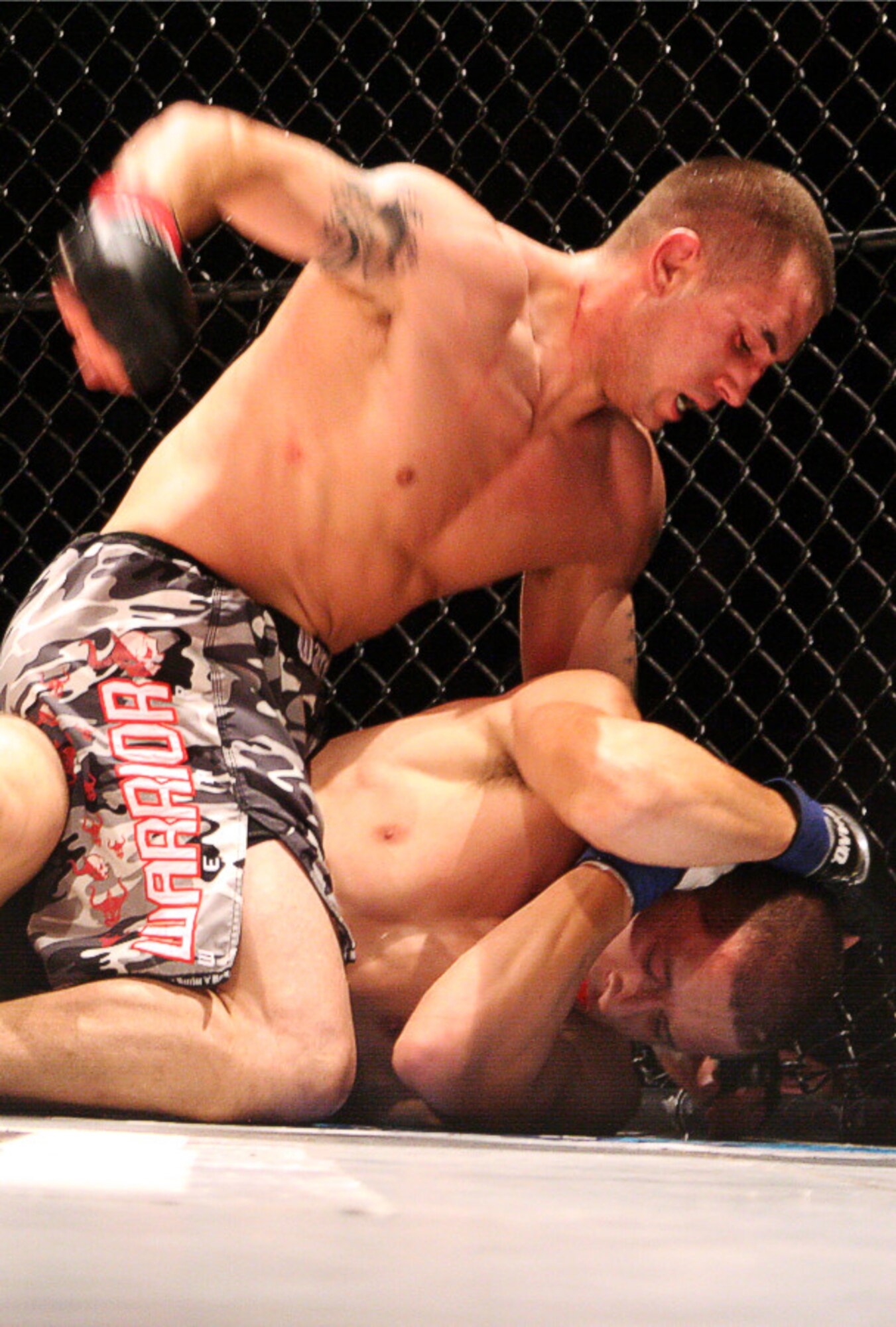 EIELSON AIR FORCE BASE, Alaska--Staff Sgt. Derrick Kennington, 354th Civil Engineer Squadron, fights against Anchorage's Michael Madrid Aug. 3 at the Alaska Fighting Championship in Fairbanks. Sergeant Kennington has been fighting locally at the Carlson Center. This recent victory was considered his first pro-fight and puts him closer to achieve the championship belt of the AFC in Anchorage. Sergeant Kennington trains under Sensei Martin Suarez, who teaches the Yudansha Fighting System out of the Baker Field House. (courtesy photo)