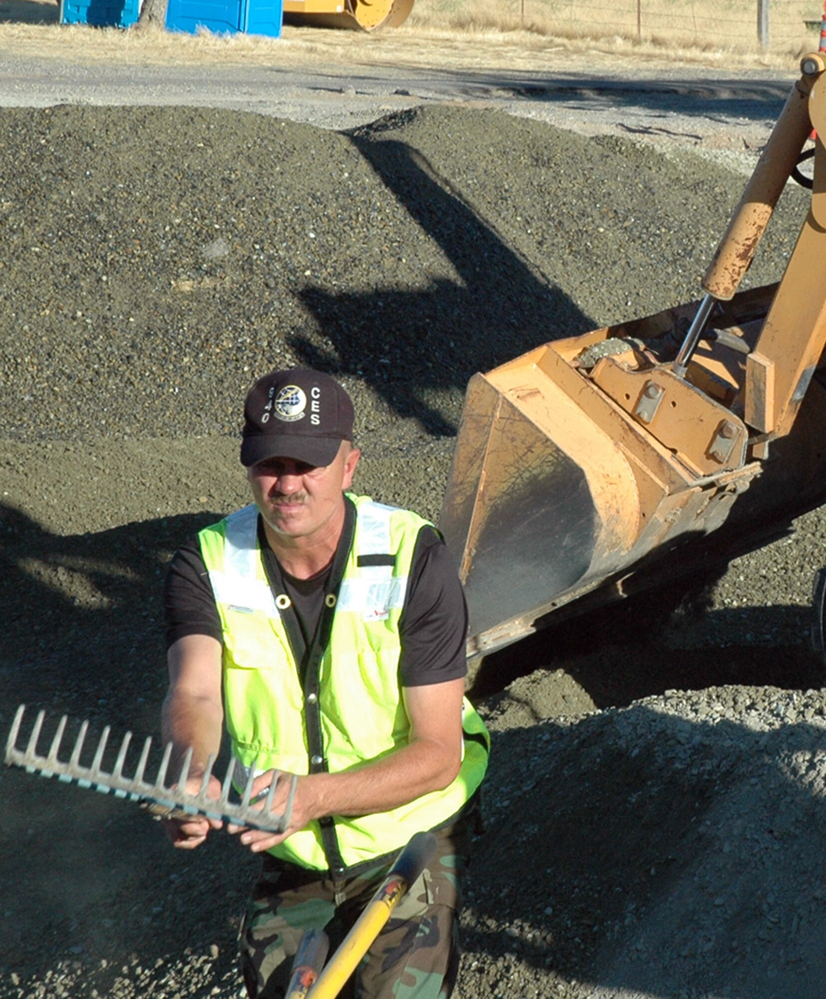 Master Sgt. Alan Carlson, a heavy equipment supervisor with the 940th Civil Engineer Squadron, Beale Air Force Base, Calif., uses a rake during a road repair project on base Aug 11. Sergeant Carlson has about 20 years experience as a bull dozer and heavy equipment operator for the City of Roseville, experience he wanted to use to tackle the project on base. The road had been degraded over the past two years after flooding caused the initial damages. Sergeant Carlson was part of an ten-man team who worked along side their active duty counterparts from the 9th CES. (US Air Force photo/Master Sgt Ellen L Hatfield)