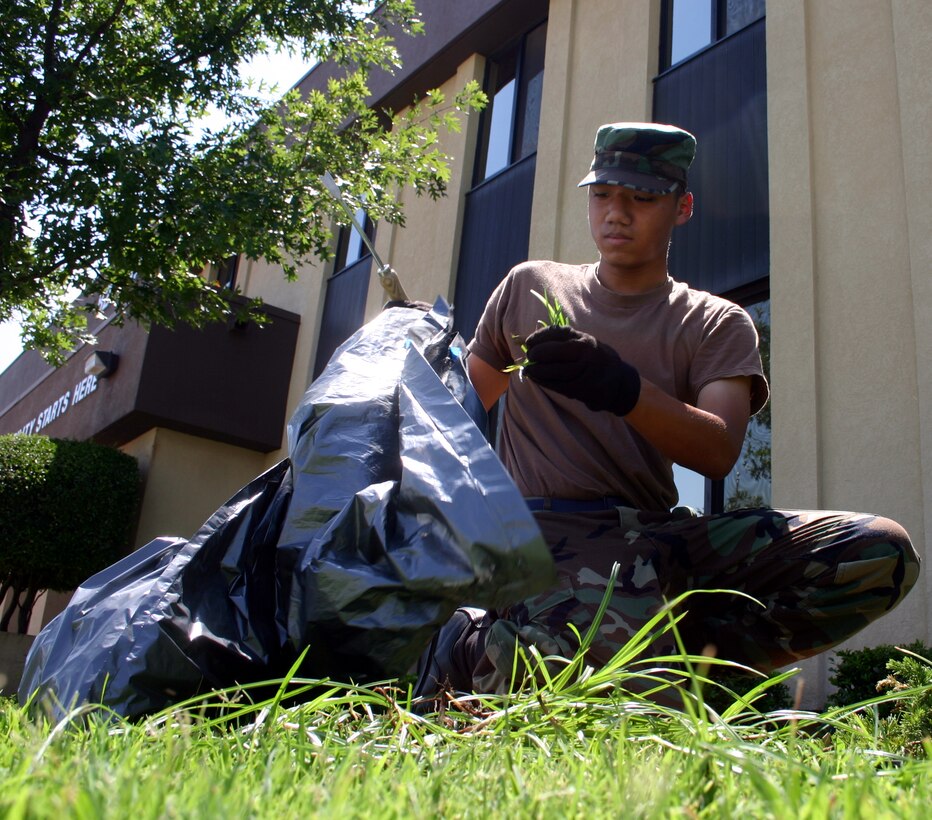 Airman Rathanak Ear, 364th Training Squadron, pulls weeds in front of Bldg. 400 as part of Base Cleanup Day Aug 20.  The basewide effort is in preparation for an Aug. 22-26 visit from Maj. Gen. Michael Gould, commander, 2nd Air Force, Keesler Air Force Base, Miss. (U.S. Air Force photo/Staff Sgt. Tonnette Thompson)