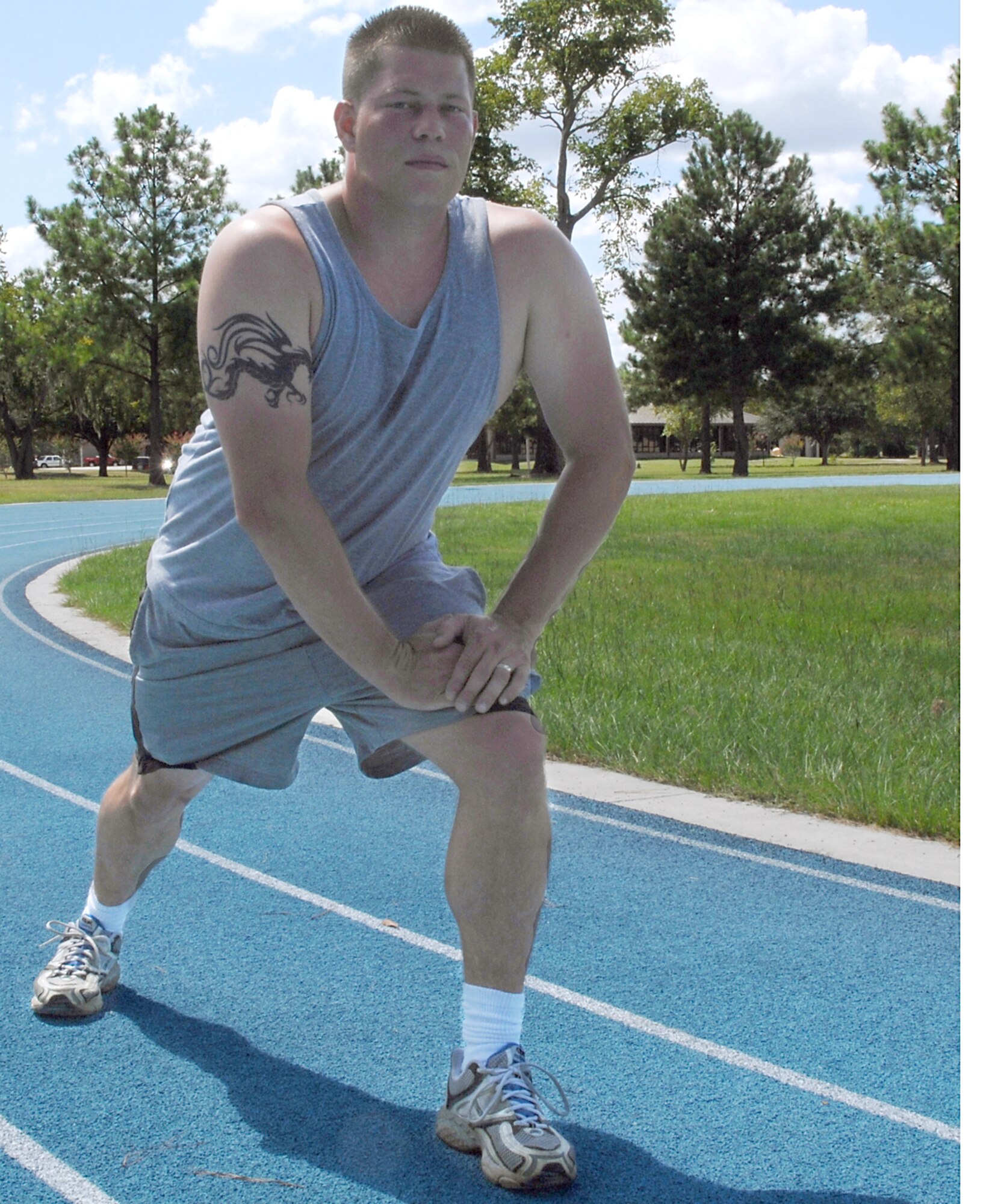 Tech. Sgt. William Nicholson, 723rd Maintenance Squadron, prepares for a run Aug. 20 at Moody's running track. People performing activity or exercise during days of extreme heat can help fight their risk of experiencing a heat-related illness by hydrating and staying aware of the conditions outside. (U.S. Air Force photo by Airman 1st Class Brittany Barker) 