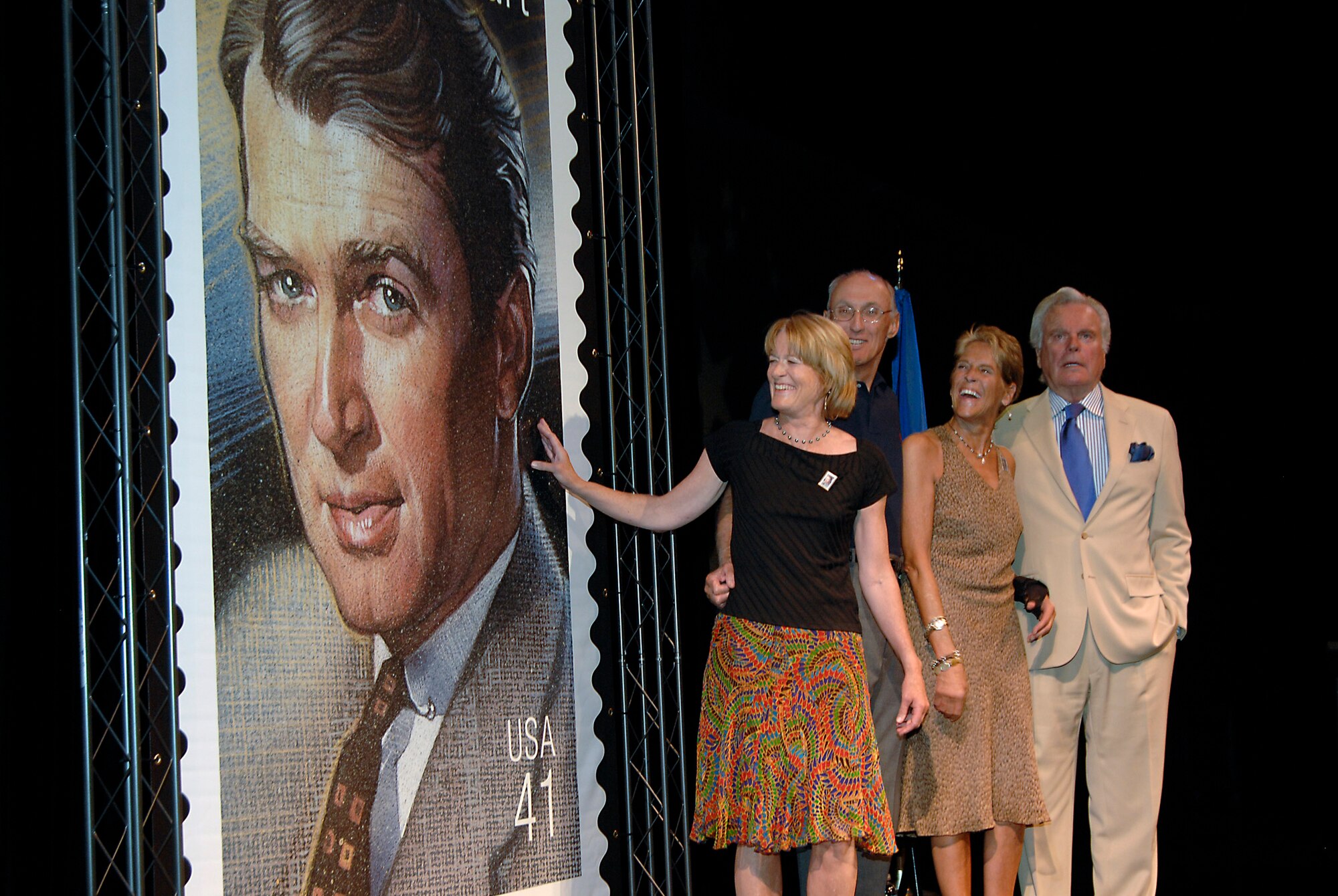 Jimmy Stewart’s children, and actor and close family friend, Robert Wagner unveil a new US Postal Service stamp honoring late actor Jimmy Stewart, Aug. 17. Lt. Col. Ivan Thompson, SMC, and an Honor Guard from March Air Reserve Base represented the Air Force at the ceremony held at Universal Studios Hollywood. Stewart, who died in 1997, served in the Army Air Corps during World War II. He flew 20 missions over Germany as a B-24 squadron commander. He later served in the Air Force Reserve – achieving the rank of brigadier general. Recently, a technology center at Bolling Air Force Base in Washington, D.C. was dedicated as the Brig. Gen. James Stewart Theater in honor of his service and his efforts to promote Air Force heritage and moral programs to  benefit future generations of Airmen. (Photo by Joe Juarez)