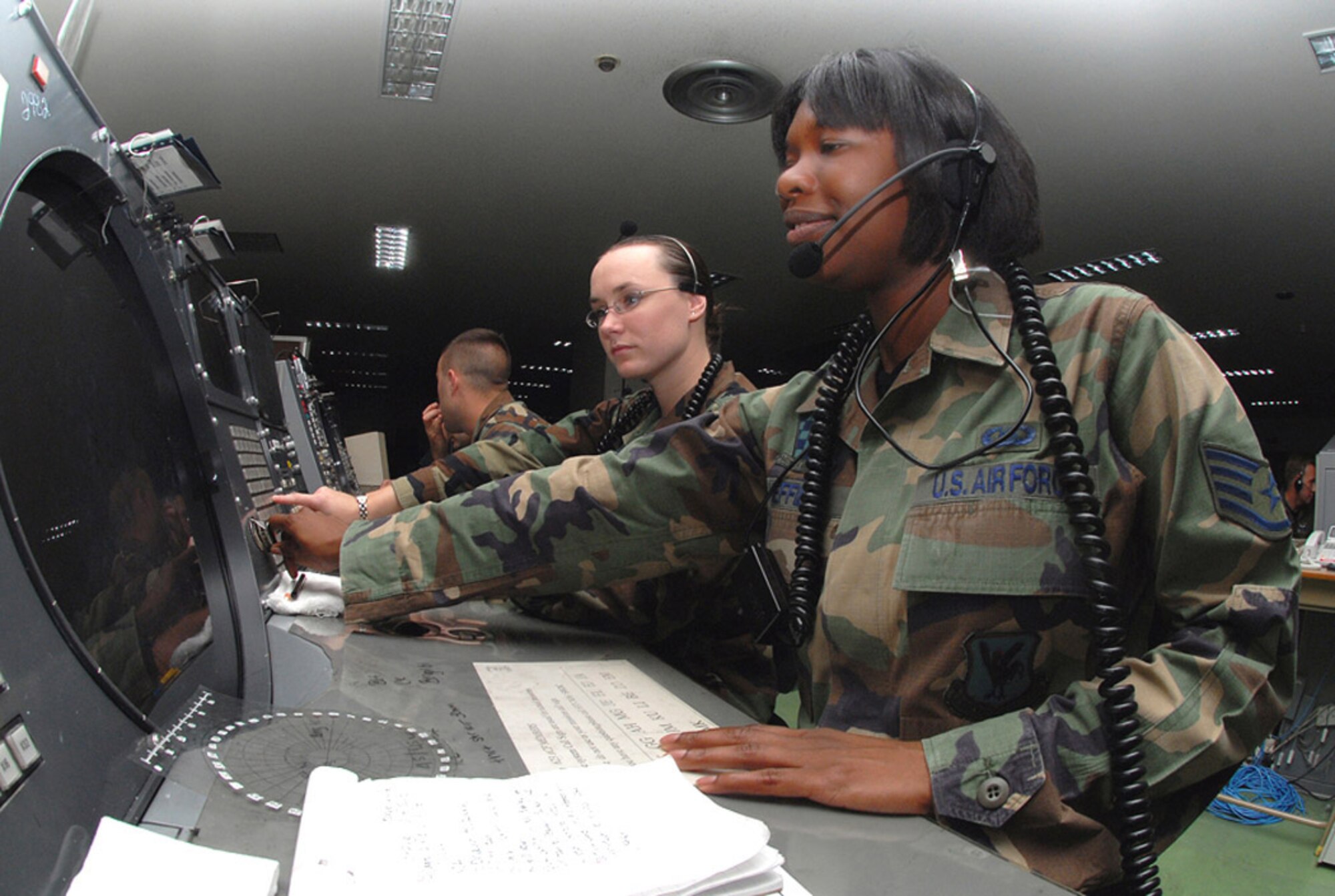 Staff Sgt. Crystal Sheffield (right) and Airman 1st Class Amber Hoedebeck control a mission by using a Base Air Defense Ground Environment system at Naha Air Base, Japan. They are weapons directors with the 623rd Air Control Flight. (U.S. Air Force photo/Staff Sgt. Steven Nabor)