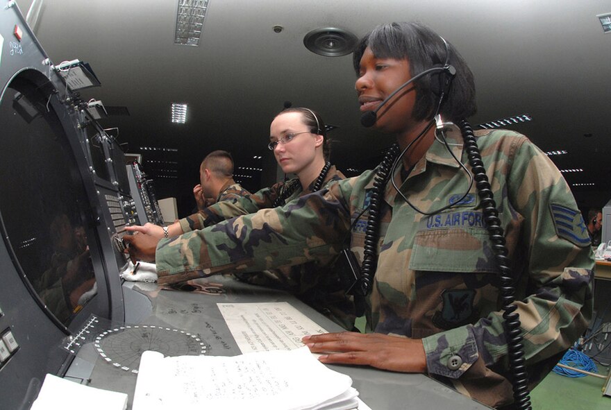 Staff Sgt. Crystal Sheffield (right) and Airman 1st Class Amber Hoedebeck, 623rd Air Control Flight weapons directors, control a mission by using a Base Air Defense Ground Environment system at Naha Air Base, Japan. Kadena Air Base's 623rd ACF is in charge of commanding and controlling 85 percent of local F-15 daily training as well as real-world operations, providing overlapping command and control support with AWACS aircraft and providing primary support when AWACS is not available. (U.S. Air Force photo/Staff Sgt. Steven Nabor)