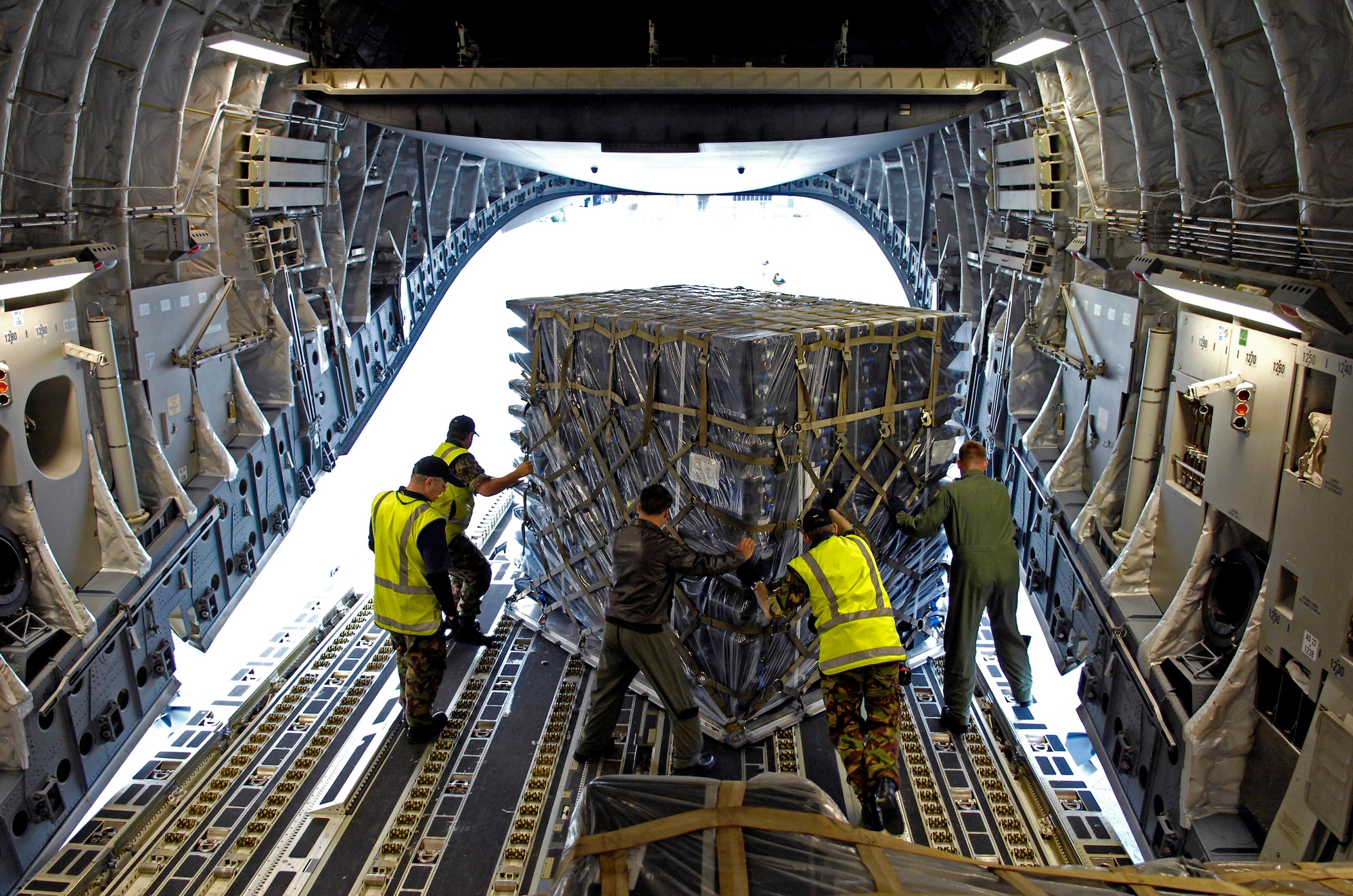 Airmen and New Zealand Defense Force terminal operations people offload a pallet from a C-17 Globemaster III at Christchurch, New Zealand, Aug. 18. The Airmen and the C-17 are at Christchurch to begin the annual winter fly-in, known as WinFly. During these flights, aircrews transport scientists, support personnel, food and equipment for the U.S. Antarctic program at McMurdo Station, Antarctica. WinFly is the opening of the first flights to McMurdo station, which closed for the austral winter in February. (U.S. Air Force photo/Tech. Sgt. Shane A. Cuomo)