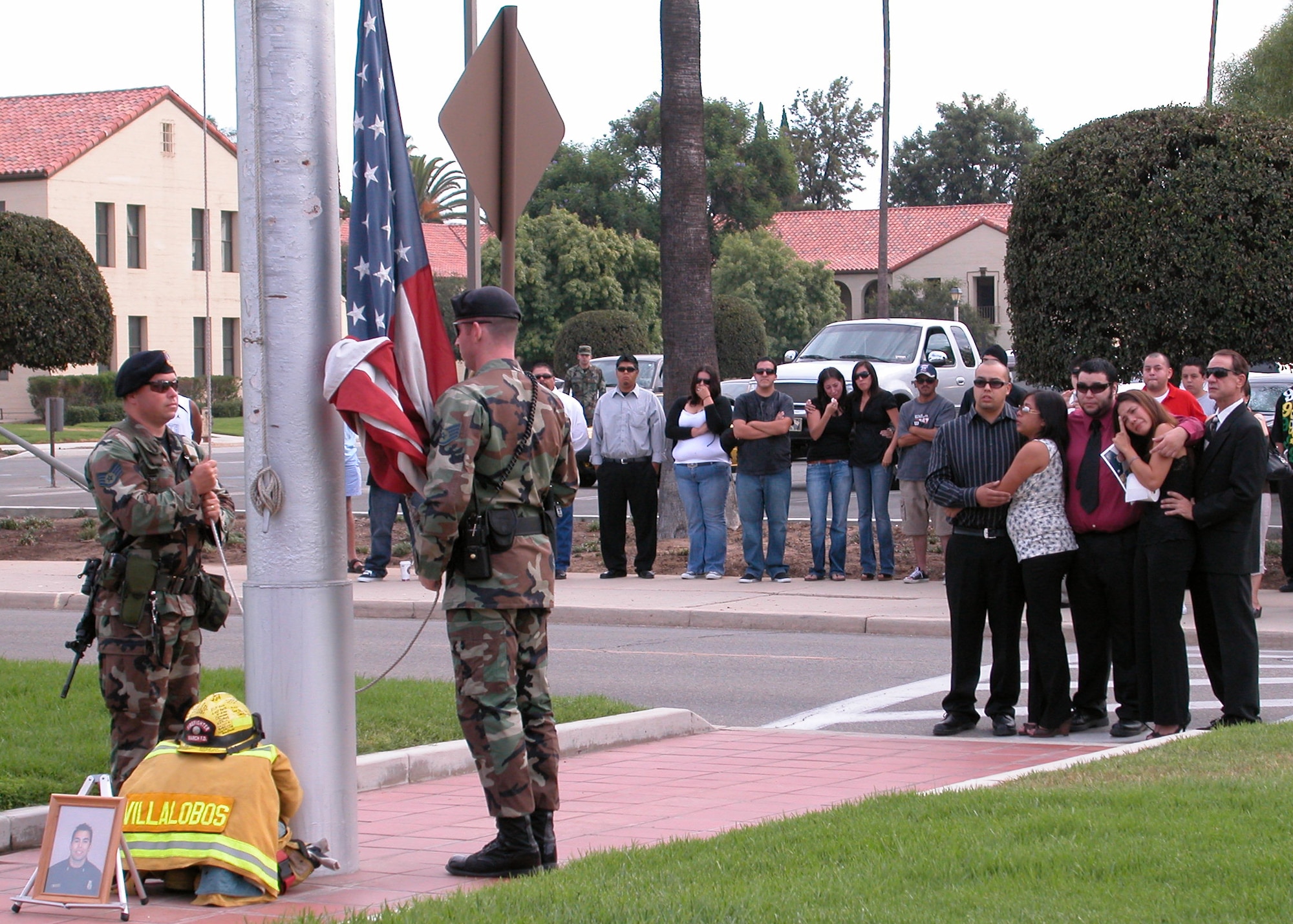Family and friends gather to honor fallen firefighter Sergeant Ricardo Villalobos.  The base flag was lowered to half staff Sunday during a traditional fallen firefighter ceremony. (U.A. Air Force photo by Capt Caroline Lorimer) 