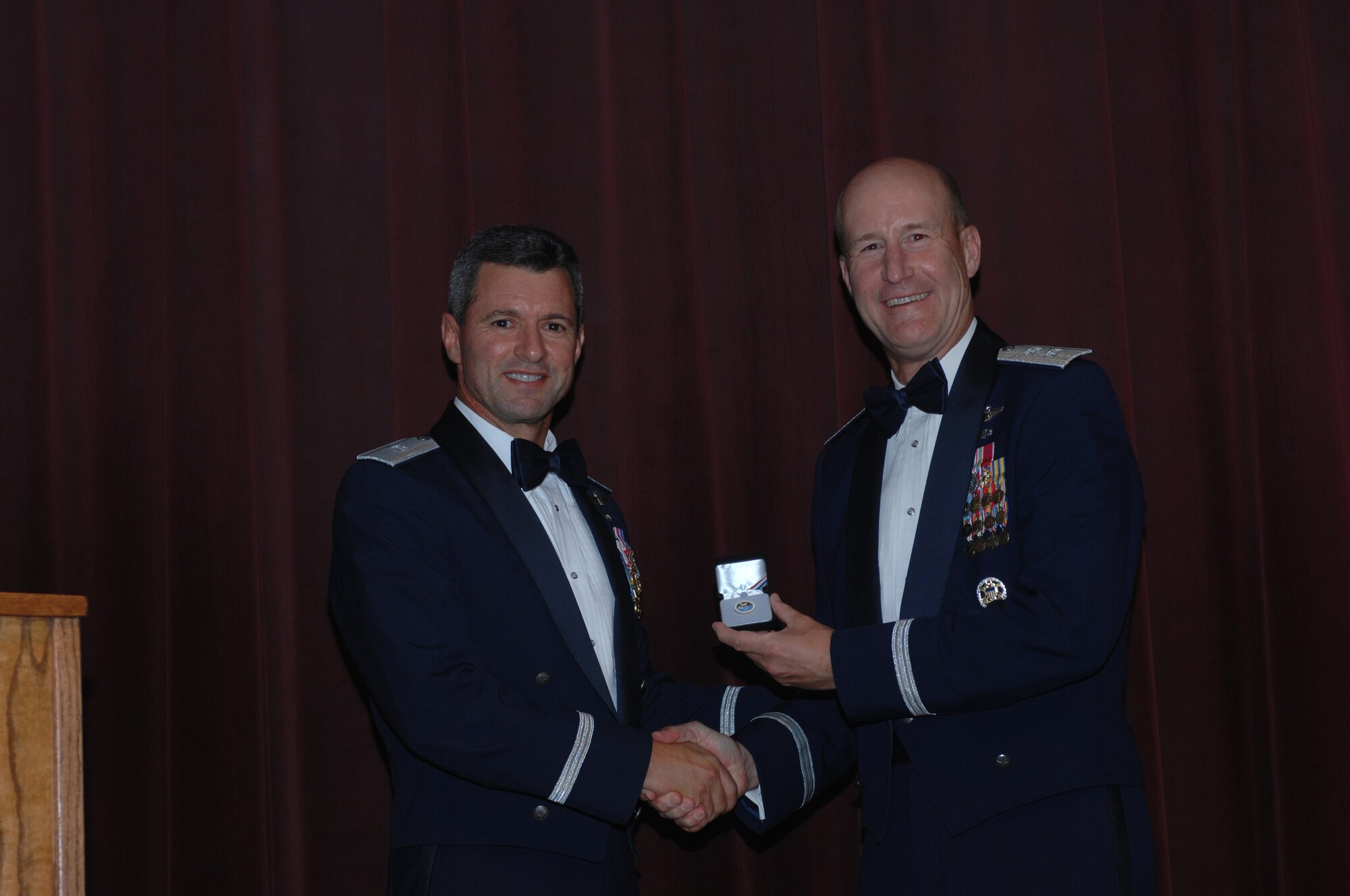 WHITEMAN AIR FORCE BASE, Mo. – Left to right: Brig. Gen. Greg Biscone, 509th Bomb Wing commander presents an Air Force 60th Anniversary coin to Maj. Gen. Douglas Raaberg, Air Combat Command air and space operations director at the Air Force Ball Aug. 18. This year’s ball commemorated the Air Force’s 60th Anniversary, and was held at Elliott Union on the University of Central Missouri campus. (U.S. Air Force photo/Tech. Sgt. Samuel Park)