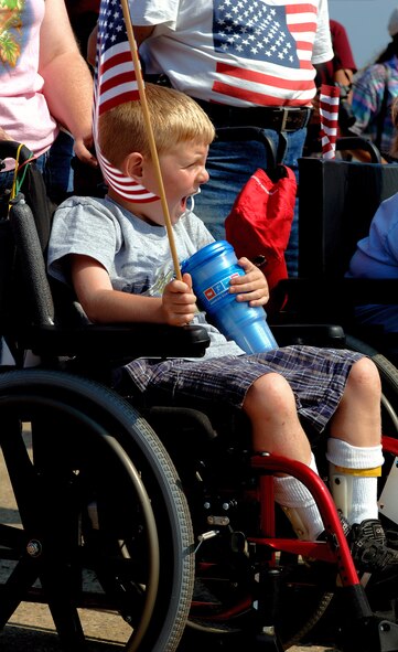 Seven-year-old Teagan from Portsmouth, N.H. cheers for the U.S. Air Force Honor Guard Drill Team during a performance for children with special needs Aug. 17 at Pease Air National Guard Base, N.H. The team's performance was a part of the 2007 Wings of Hope Air Show at Pease in conjunction with Air Force Week New England. (U.S. Air Force photo/Staff Sgt. Bennie J. Davis III) 
