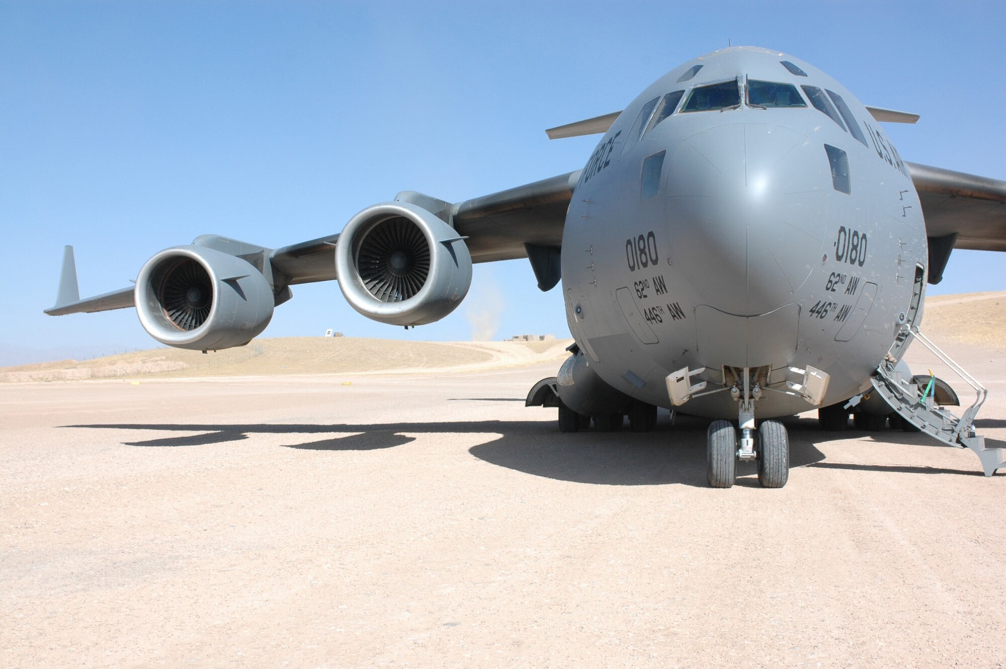 A C-17 Globemaster III awaits cargo at a forward-deployed location. The C-17 is the newest, most flexible cargo aircraft to enter the airlift force. The C-17 is capable of rapid strategic delivery of troops and all types of cargo to main operating bases or directly to forward bases in the deployment area. Coalition C-17s and C-130s flew 156 sorties and delivered more than 785 tons of cargo Aug. 19.  (U.S. Air Force photo/Capt. Teresa Sullivan)