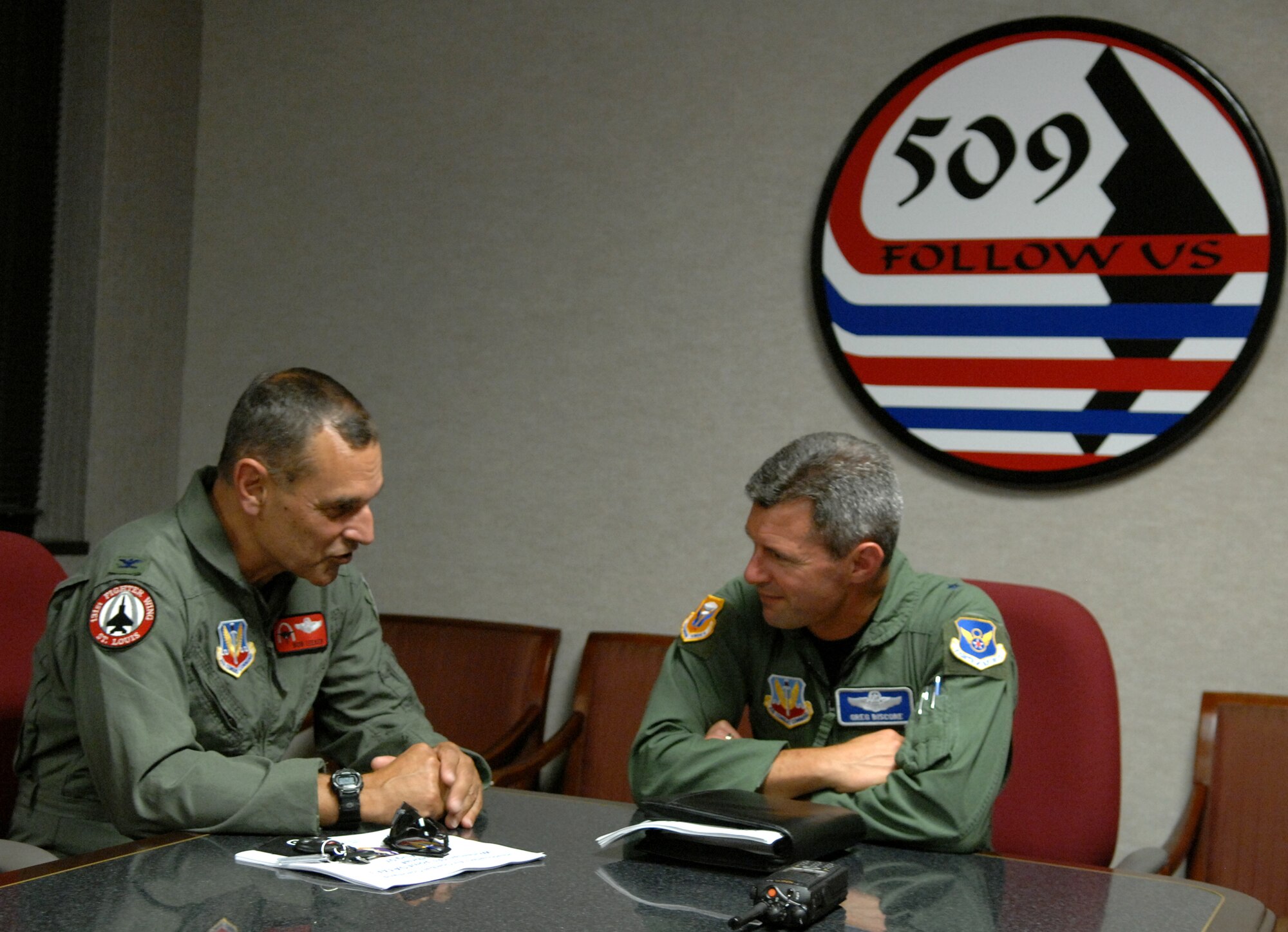 Brig. Gen. Greg Biscone, 509th Bomb Wing commander, and Col. Robert Leeker, 131st Fighter Wing commander, converse after an outbrief here Aug. 16. (U.S. Air Force photo/Airman1st Class Stephen Linch)