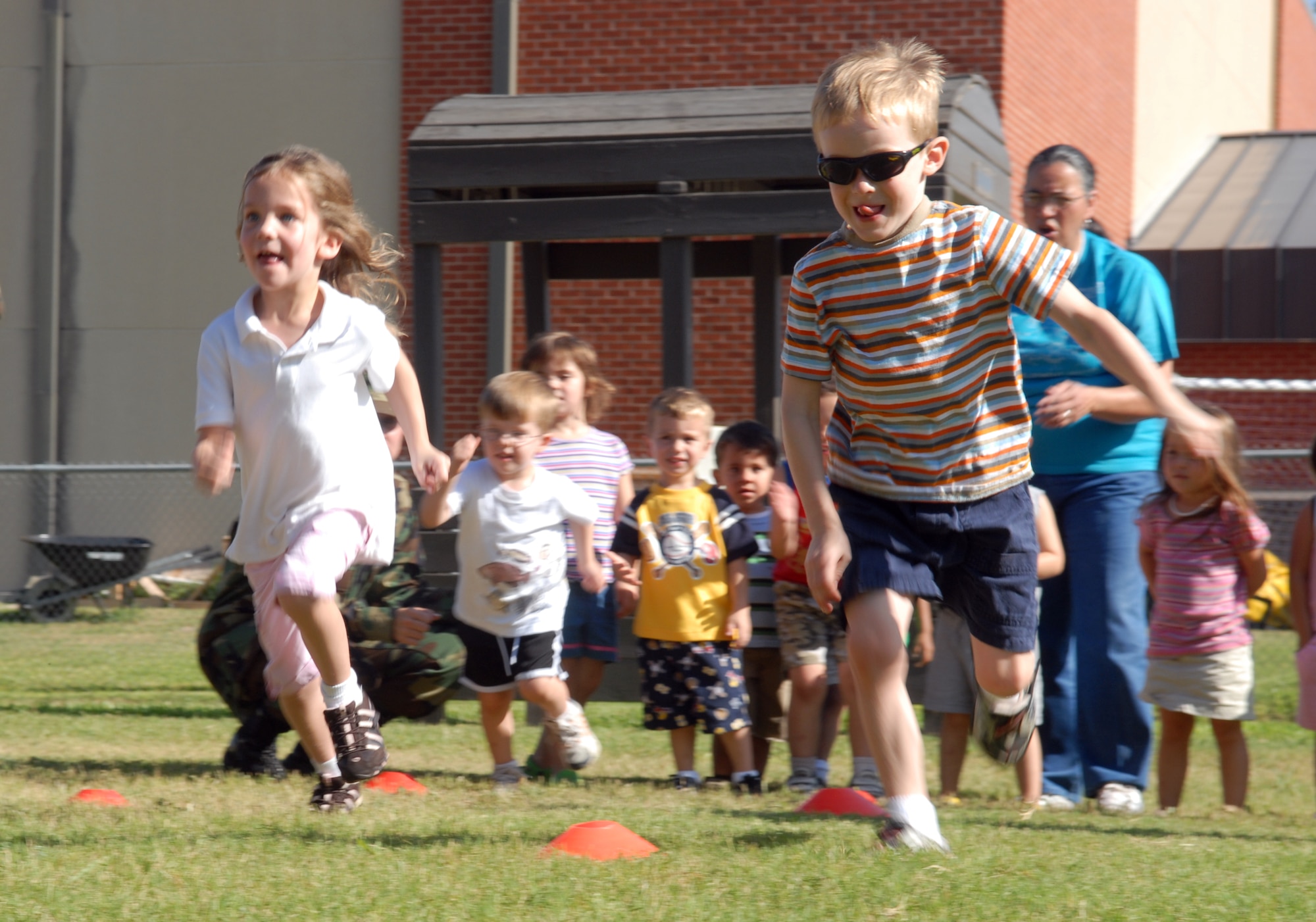 Little Olympians charge to the finish line during the 2-yard dash at the Goodfellow Air Force Base Child Development Center’s Little Olympics Aug. 10. (U.S. Air Force photo by Airman 1st Class Kamaile Chan)