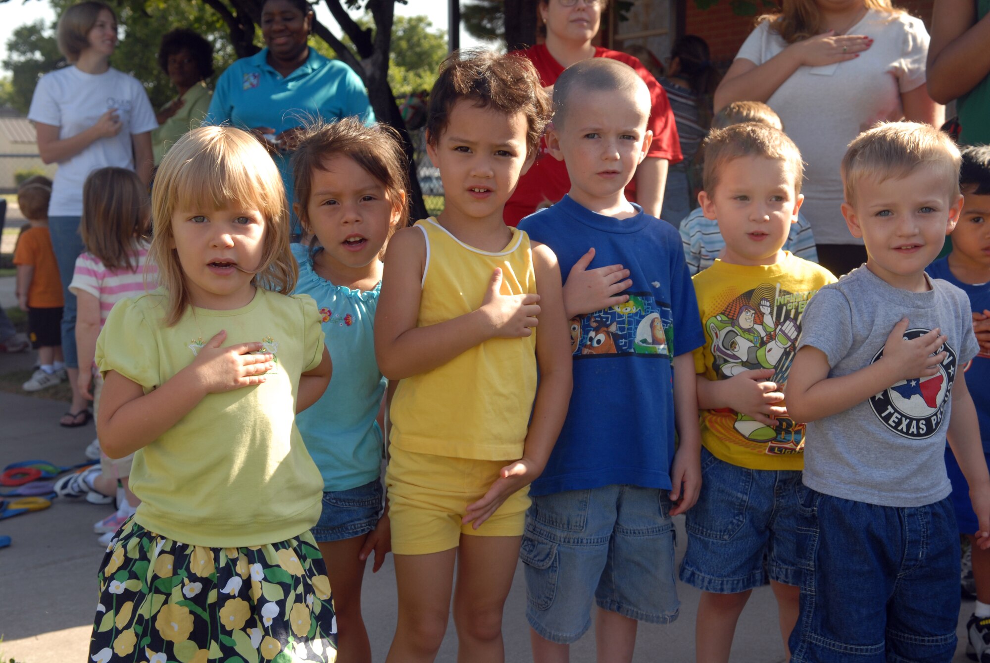 Participants in the Goodfellow Air Force Base Child Development Center’s Little Olympics recite the Pledge of Allegiance during opening ceremonies Aug. 10. (U.S. Air Force photo by Airman 1st Class Kamaile Chan)