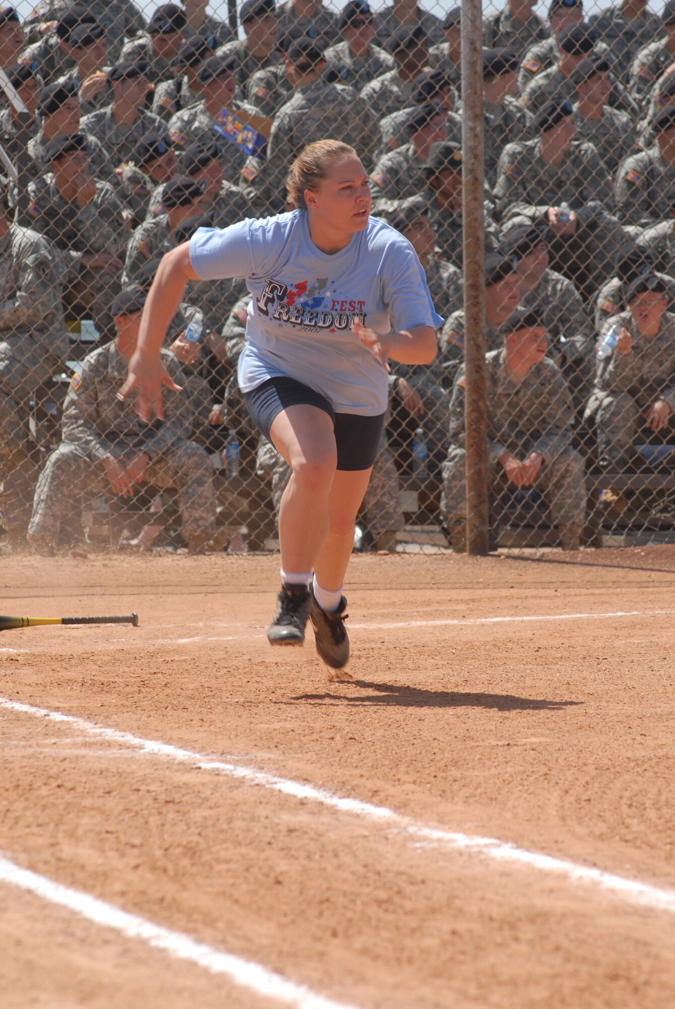 Carmen Nila, catcher for the Air Force team, speeds toward first base at the Army versus Air Force Co-Ed Softball Game Aug. 10. (U.S. Air Force photo by Airman 1st Class Kamaile Chan)