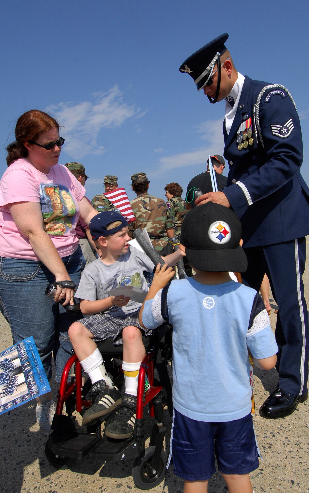 Staff Sgt. Michael Doss, Drill Team member, speaks about his AF experience on the Drill Team and as a B-1 Crew Chief while autographing cards for children at the Pease ANGB, NH.  During the Air Force Week events, the Drill Team performed for an invite-only crowd of 300 kids who are part of the New England area Make-a-Wish foundation. (U.S Air Force photo by Airmen 1st Class Alexandre Montes)