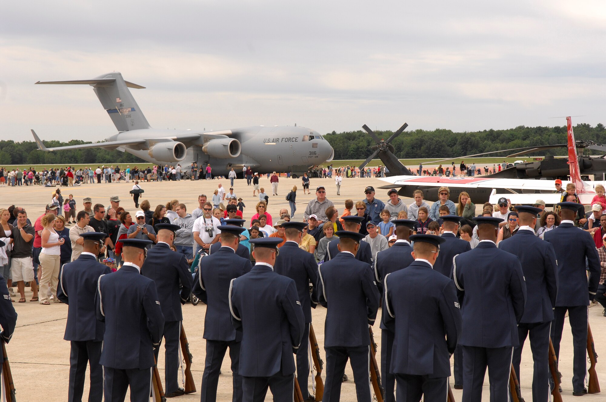 The USAF Honor Guard Drill Team stands ready just before performance for an eager crowd at the Wings of Hope Air Show.  The air show was held at Pease ANGB, NH, and included Tops in Blue in their celebration of Air Force Week in New England. (U.S. Air Force photo by Airmen 1st Class Alexandre Montes)(Released)