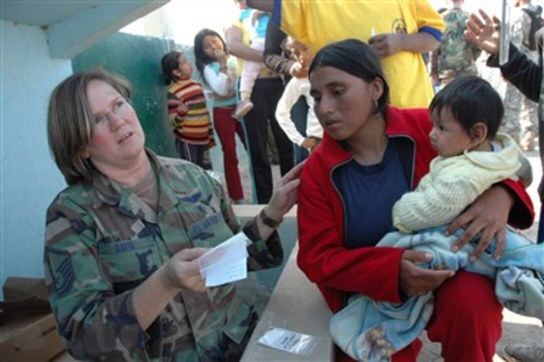 U.S. Air Force Master Sgt. Deborah Davis explains a prescription to a Peruvian patient in Pisco, Peru, on Aug. 18, 2007.  The Department of Defense has deployed a 30-person mobile surgical team from Joint Task Force-Bravo at Soto Cano Air Base, Honduras, and a 14-person U.S. Air Force medical team from Goodfellow Air Force Base, Texas, to Peru to provide aid to victims of the 8.0 magnitude earthquake that struck Western Peru on Aug. 15th.† U.S. Southern Command has purchased $50,000 in medical supplies that will be donated to Peruvian Ministry of Health officials.  