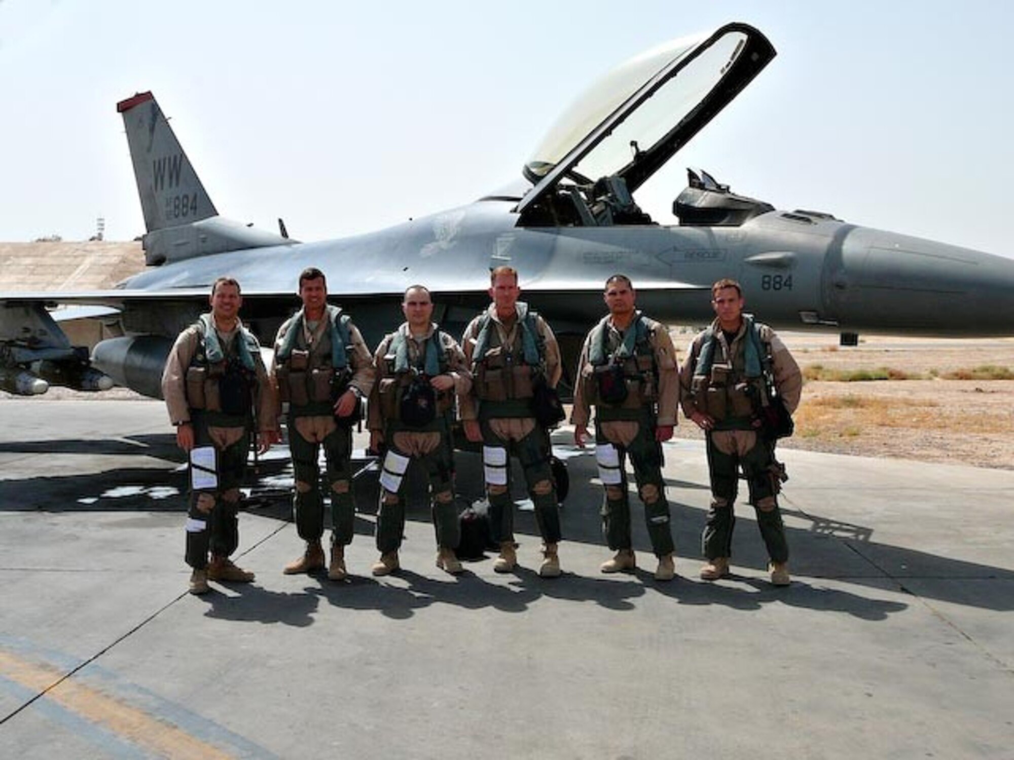 BALAD AIR BASE, Iraq -- From left: Lt. Col. Steve Williams, 13th Expeditionary Fighter Squadron commander (name unknown) the 332nd Expeditionary Operations Group commander, Capt. Larry Sullivan, 13th EFS pilot, Capt. Chris Struve, 332nd EOG F-16 pilot, Maj. Mike Briggs, 13th EFS pilot and Capt. Kevin Hicock, 13th EFS pilot prepare for a combat mission Aug. 12. All are deployed from Misawa Air Base, Japan. (U.S. Air Force photo)
