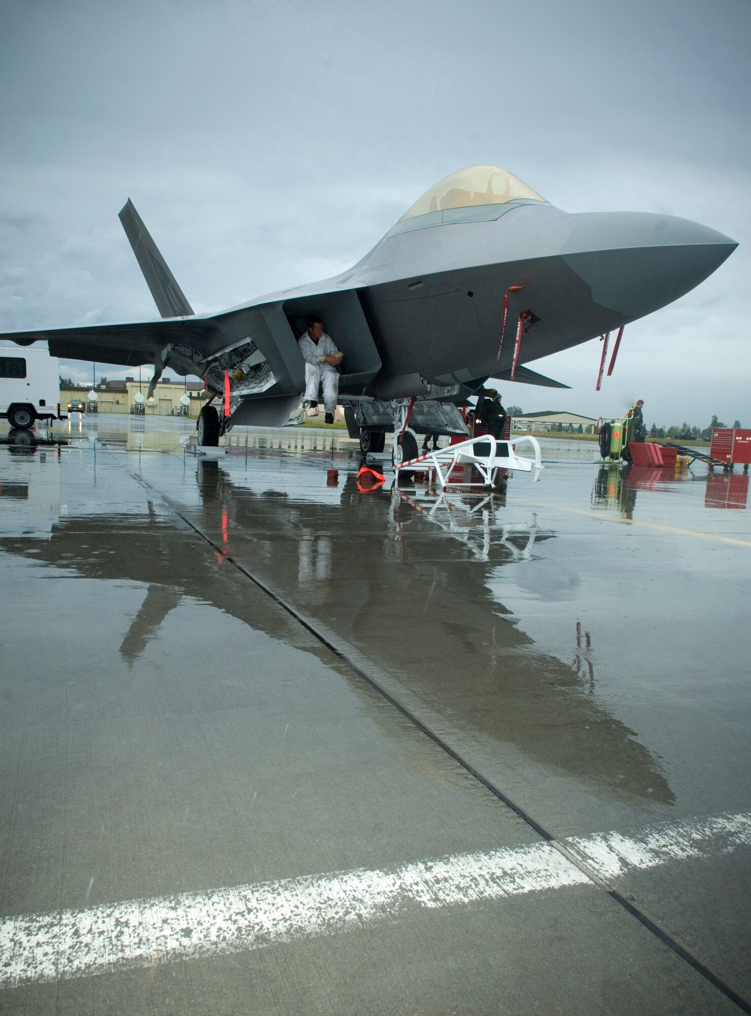 ELMENDORF AIR FORCE BASE, Alaska -- Staff Sgt. Brian Sarafin, 90th Aircraft Maintenance Unit, finishes suiting up to perform an inspection of the F-22's intake exhaust before the demonstration here Aug. 20. The demo was the closing event of the 90th Fighter Squadron's 90th anniversary. (U.S. Air Force photo by Senior Airman Garrett Hothan)       