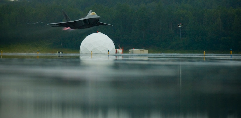 ELMENDORF AIR FORCE BASE, Alaska -- The F-22 takes off with afterburners during the 12-minute demonstration here Aug. 20. The demo was the closing event of the 90th Fighter Squadron's 90th anniversary. The aircraft was flown by Maj. Paul Moga, the Air Force's sole F-22 Raptor demonstration pilot. He is assigned to the 1st Operations Group at Langely Air Force Base, Va. (U.S. Air Force photo by Senior Airman Garrett Hothan)       