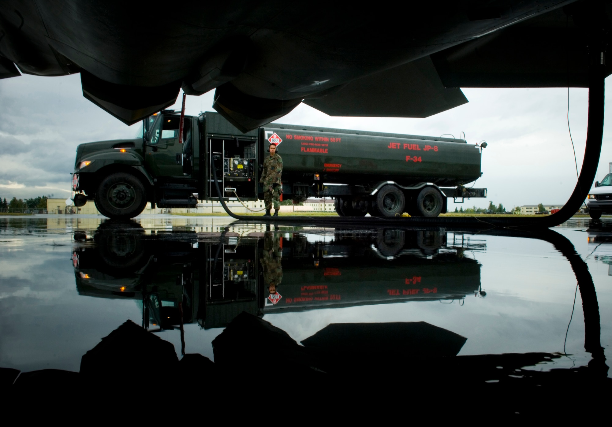 ELMENDORF AIR FORCE BASE, Alaska -- Airman 1st Class Michael Herman, 3rd Logisitics Readiness Squadron Fuels Flight, refuels the F-22 Raptor after a demonstration here Aug. 20. (U.S. Air Force photo by Senior Airman Garrett Hothan)