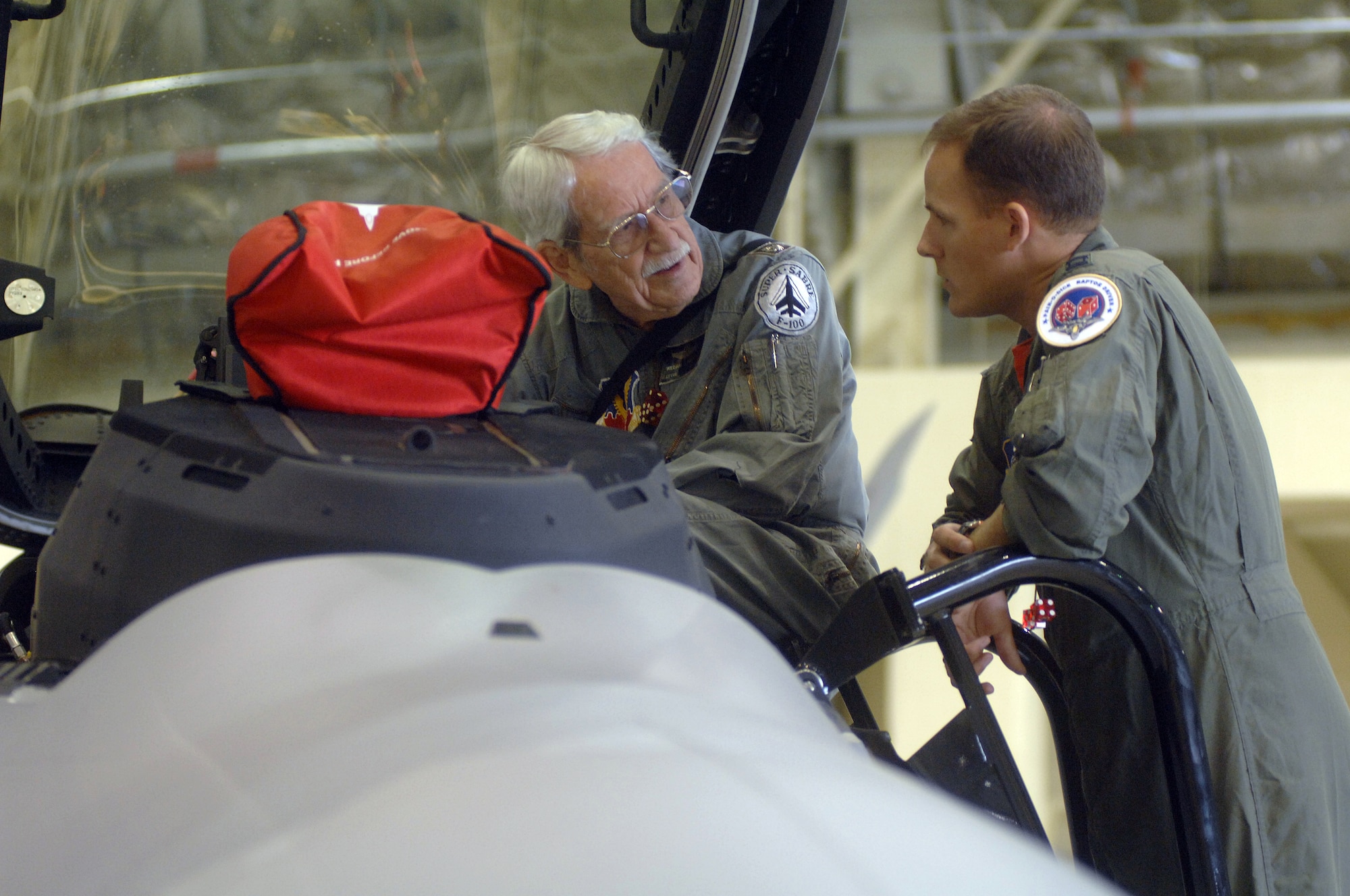 ELMENDORF AIR FORCE BASE, Alaska -- Capt. Brad Spears, 90th Fighter Squadron, tells retired Lt. Col. Bill Haynes about the capabilities of the F22A Raptor. Former and current 90th FS members celebrated the squadron's 90th anniversary Aug. 17-20. Colonel Haynes was commander of the 90th FS during the Vietnam War. (U.S. Air Force photo by Senior Airman De-Juan Haley)