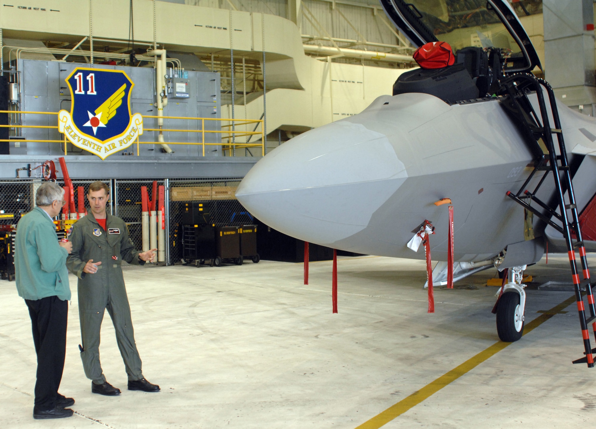 ELMENDORF AIR FORCE BASE, Alaska -- Maj. Dave Elliott, 90th Fighter Squadron, talks about the being a member of the 90th with Ted Parsons of Anchorage. Mr. Parsons was assigned the then-90th Tactical Fighter Squadron when its home station was Clark Air Base, Philippines, in 1974. (U.S. Air Force photo by Senior Airman De-Juan Haley)  