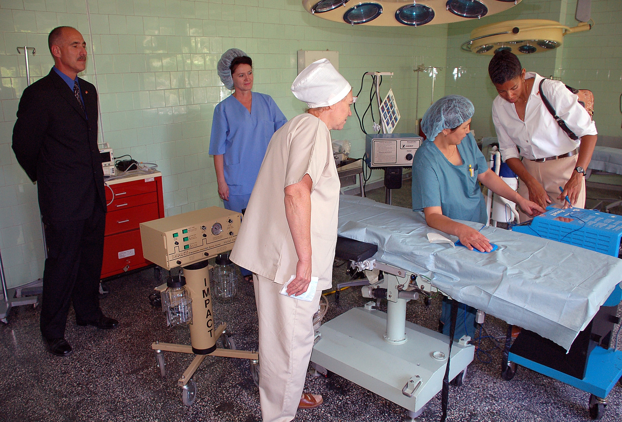 Maj. Stephanie Gardner provides training to Chinara Djanaera, an operating nurse from the National Center of Oncology, following the hand-over ceremony of humanitarian medial equipment from the 376th Expeditonary Medical Group to three hospitals in Bishkek, Kyrgyzstan. Col. David Hocking, 376th EMDG commander, and two other nurses observe the training. The National Center of Oncology was one of three hospitals to receive the medical equipment. Major Gardner is a nurse anesthetist with the 376th EMDG. (U.S. Air Force photo/Staff Sgt. Les Waters) 