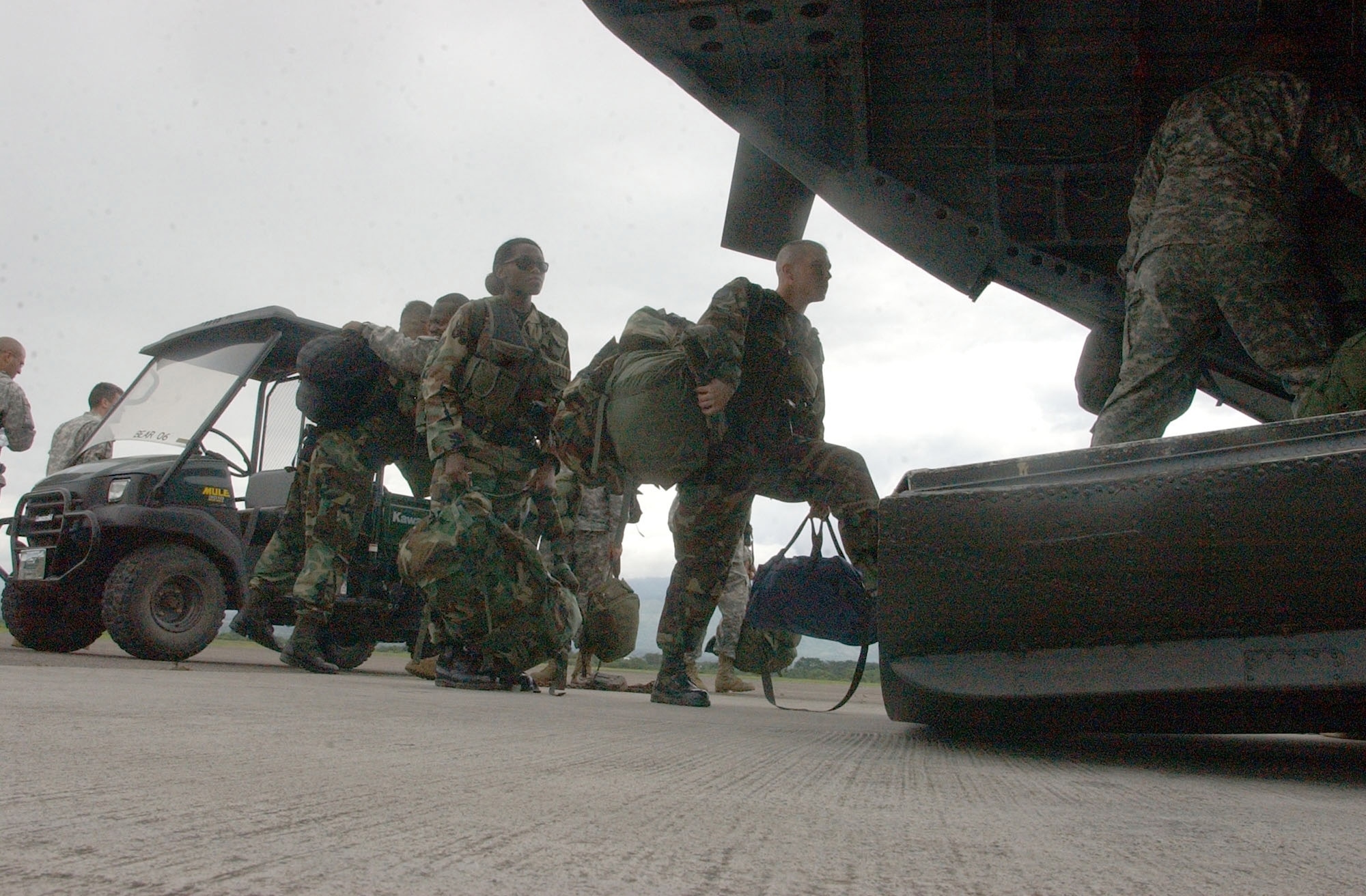 Soldiers and Airmen from Joint Task Force-Bravo at Soto Cano Air Base, Honduras, board an awaiting helicopter for the flight to Belize. They will be assessing the damage caused by Hurricane Dean in Belize to determine the amount of assitance that will needed. (U.S. Air Force photo/Martin Chahin)