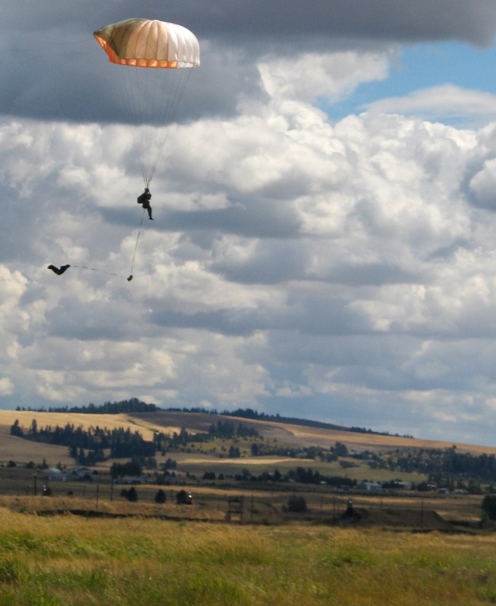 FAIRCHILD AIR FORCE BASE, Wash. – A Survival, Evasion, Resistance and Evasion school instructor from the 22nd Training Squadron here perform demonstration parachute jumps for SERE students every week. Here, an instructor prepares to land after jumping from a UH-1 Huey at 2,000 feet. A four-man SERE instructor team from the base recently proved their expert parachuting skills at Leapfest 2007, an international parachuting competition. The 22nd TRS team placed fourth in the competition, against a total of 59 U.S. and international teams. (U.S. Air Force photo / Staff Sgt. Connie L. Bias)