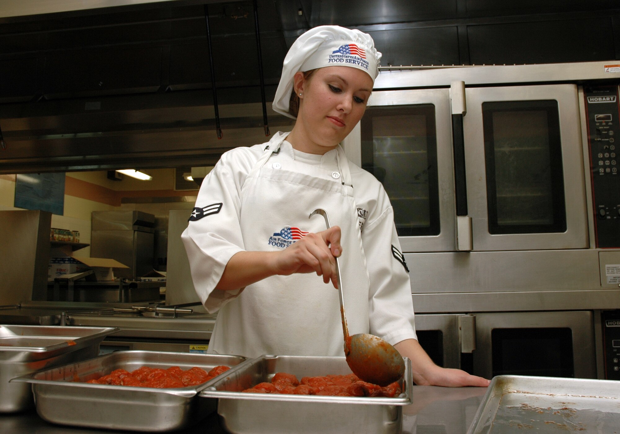 MOUNTAIN HOME AIR FORCE BASE, Idaho -- Airman 1st Class April L. Severson, a food service apprentice at the Wagon Wheel dining facility here, prepares food for the lunchtime meal Aug. 20.  The Wagon Wheel was selected, along with the Trailwinds Flight Kitchen, to represent Air Combat Command in the 2008 John L. Hennessy Trophy competition. (U.S. Air Force photo/ Staff Sgt. Rodney D. Ivey)