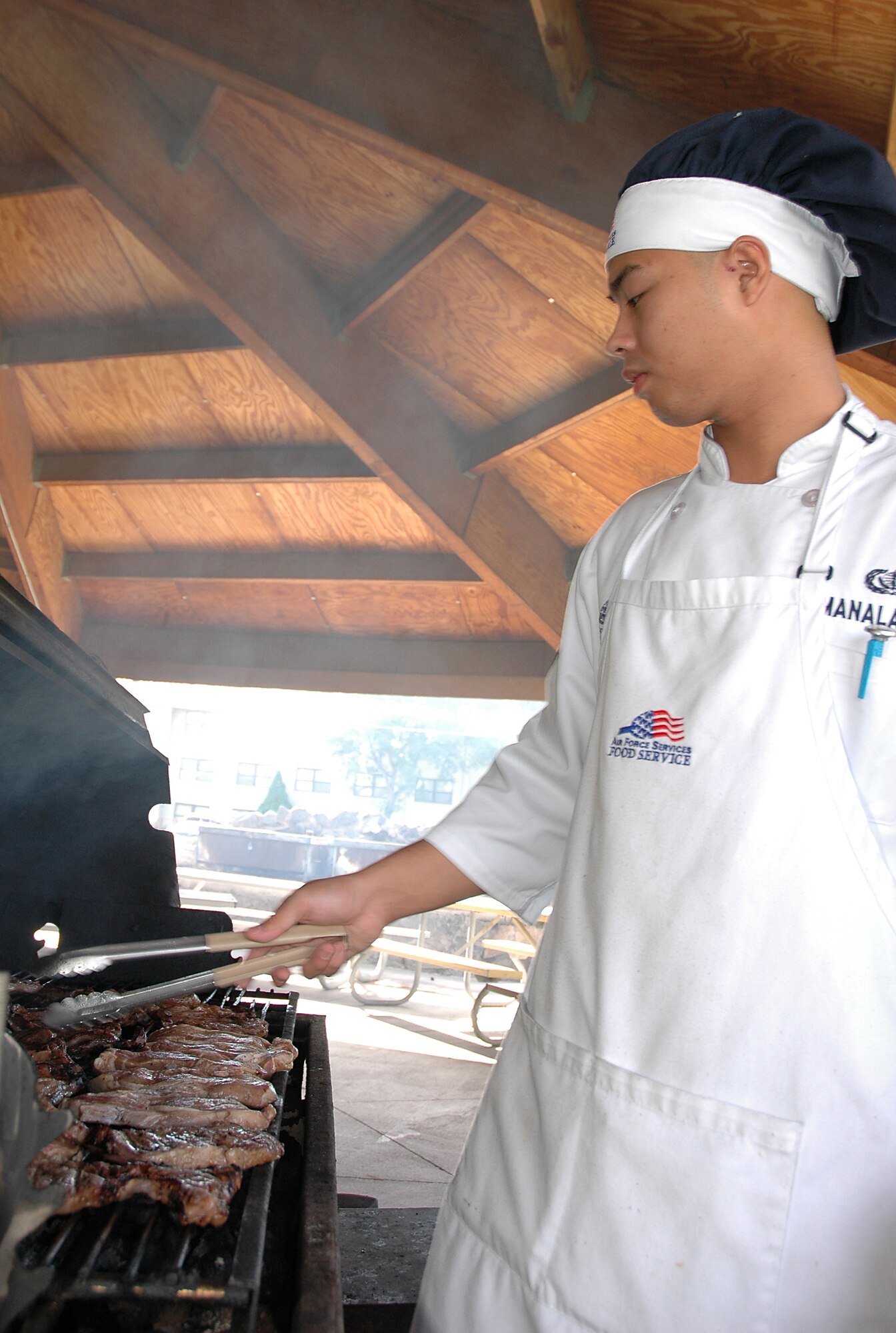 MOUNTAIN HOME AIR FORCE BASE, Idaho -- Airman 1st Class Stanley Manalansan, a food service apprentice at the Wagon Wheel Dining Facility here, grills steaks for the lunchtime meal Aug. 20.  The Wagon Wheel was selected, along with the Trailwinds Flight Kitchen, to represent Air Combat Command in the 2008 John L. Hennessy Trophy competition. (U.S. Air Force photo/ Staff Sgt. Rodney D. Ivey)