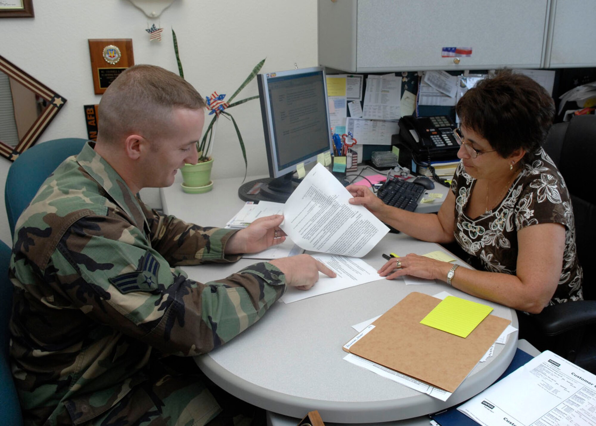 Ms. Chandell Gill, educational services guidance counsler explains to an Airman how easy is can be for him to earn his Community College of the Air Force associates degree by taking a few more college courses. The Base Training and Education Services Center was recently awarded the Nathan Altschuler Award and the CCAF Outstanding Performance Award for services provided and the amount of CCAF degrees aquired. (U.S. Air Force photo/ Airman 1st Class Rachel Kocin)