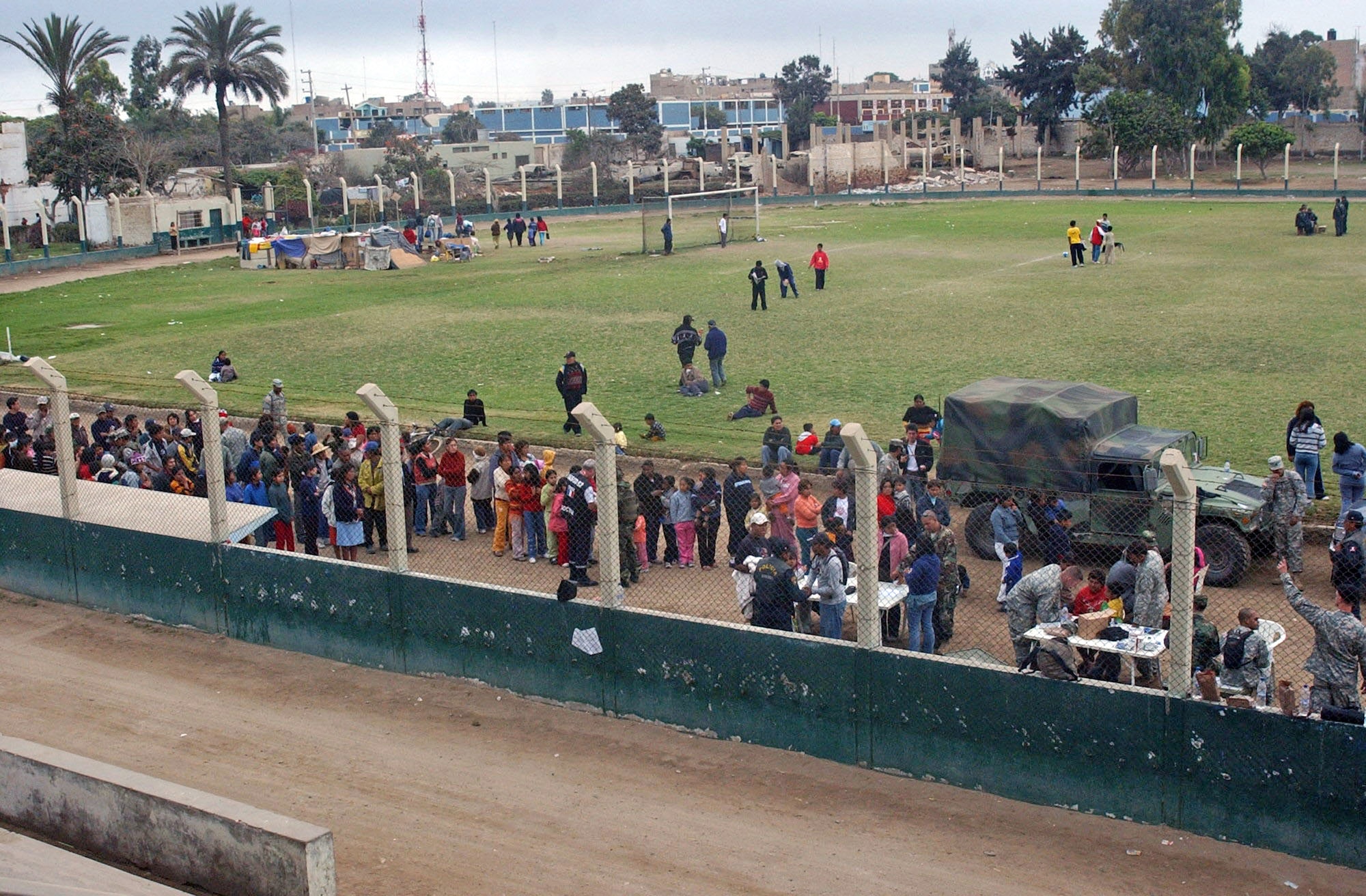 Crowds of people line up to receive medical care Aug. 20 at Pisco, Peru, from members of Joint Task Force-Bravo from Soto Cano Air Base, Honduras. The task force members are providing medical humanitarian care to the people affected by the 8.0 magnitude earthquake that struck the region Aug. 15, causing major damage as well as killing and injuring numerous people. (U.S. Air Force photo/Senior Airman Shaun Emery) 
