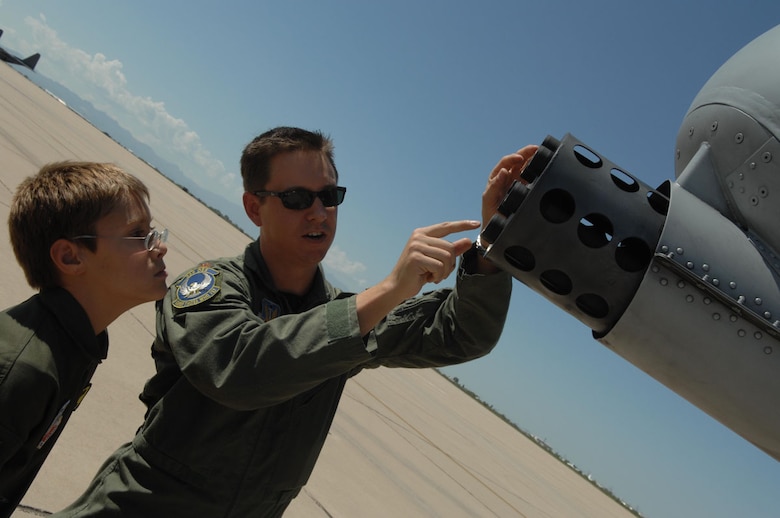 Major Chris Zentner, an A-10 Thunderbolt II pilot with the 354th Fighter Squadron shows 10-year-old Brandon Smalling the gun on an A-10, Thursday August 10 at Davis-Monthan AFB, Ariz as part of the Pilot for a Day program. The program is designed to help children with disabilities or serious illnesses to enjoy a day focused on them and their interest in aviation. Activities in the program include; trying on life support equipment, using Night Vision goggles, flying an A-10 simulator, and seeing an A-10  up close. (U.S. Air Force photo/Senior Airman Christina D. Kinsey)
