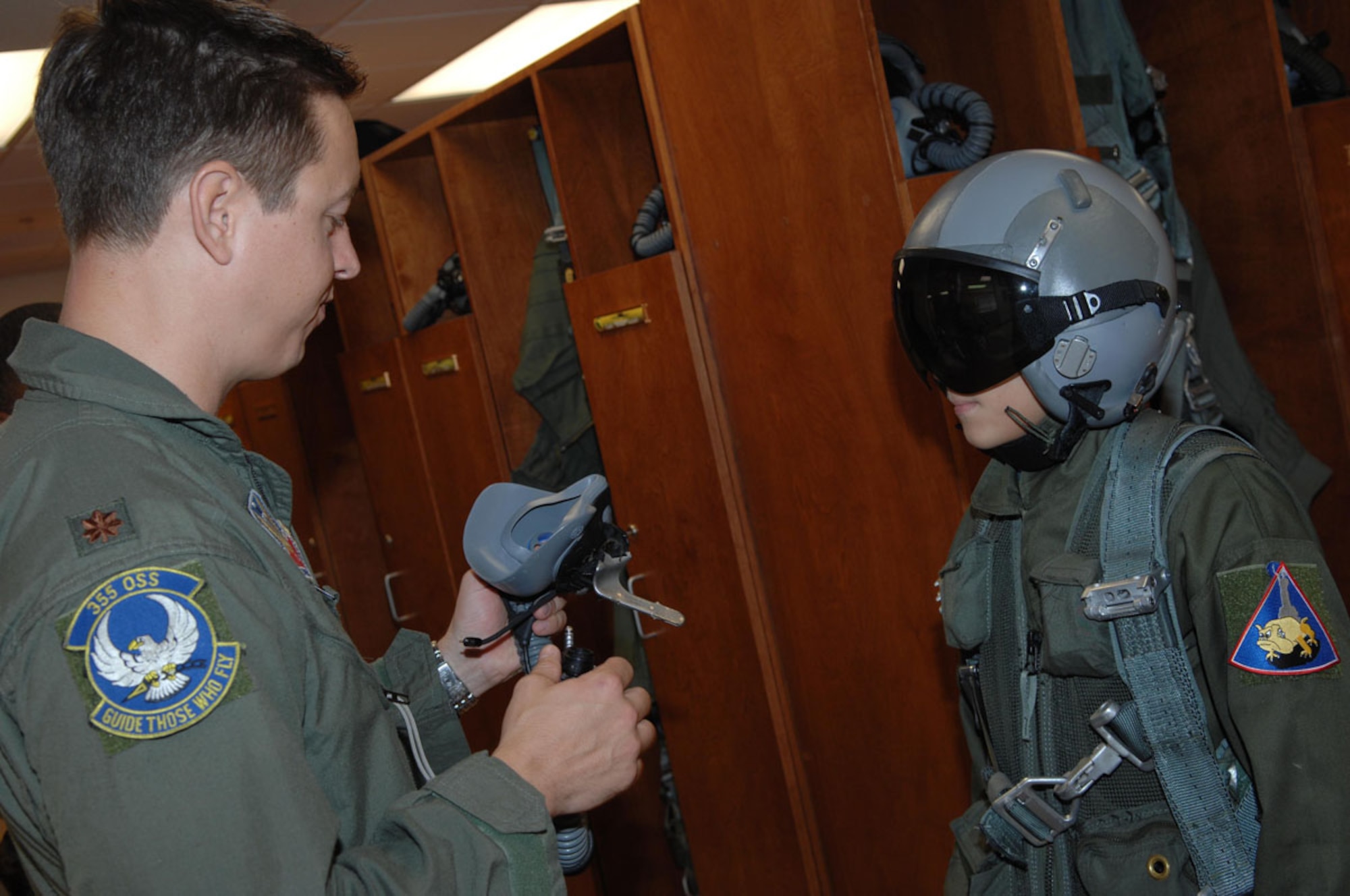 Major Chris Zentner, an A-10 Thunderbolt II pilot with the 354th Fighter Squadron helps 10-year-old Brandon Smalling try on life support gear, Thursday August 10 at Davis-Monthan AFB, Ariz as part of the Pilot for a Day program. The program is designed to help children with disabilities or serious illnesses to enjoy a day focused on them and their interest in aviation. Activities in the program include; trying on life support equipment, using Night Vision goggles, flying an A-10 simulator, and seeing an A-10  up close.(U.S. Air Force photo/Senior Airman Christina D. Kinsey)
