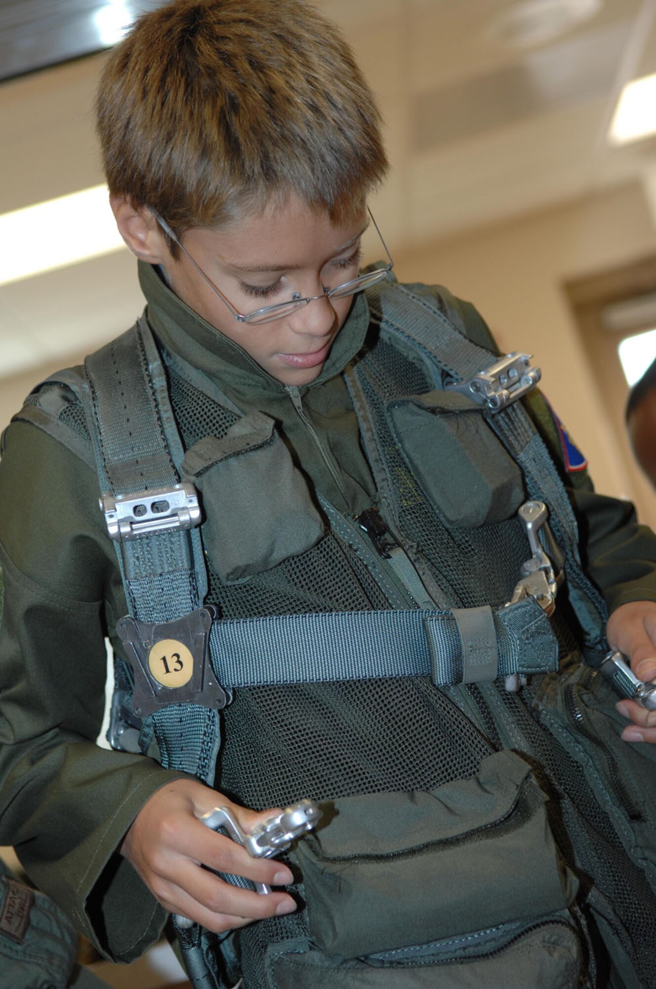 Ten-year-old Brandon Smalling tries on life support gear, Thursday August 10 at the 357th Fighter Squadron at Davis-Monthan AFB, Ariz as part of the Pilot for a Day program. The program is designed to help children with disabilities or serious illnesses to enjoy a day focused on them and their interest in aviation. Activities in the program include; trying on life support equipment, using Night Vision goggles, flying an A-10 simulator, and seeing an A-10  up close.(U.S. Air Force photo/Senior Airman Christina D. Ponte)