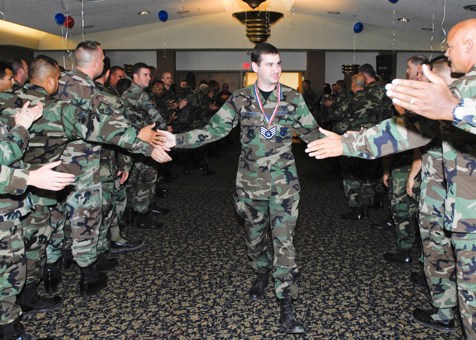 Team Edwards congratulates Senior Airman Daniel Edwards, 95th Air Base Wing Command Post controller, during the Staff Sergeant Promotion release party at Club Muroc Aug. 17. Seventy Edwards senior airmen were selected for promotion to staff sergeant. (Photo by Mike Cassidy)