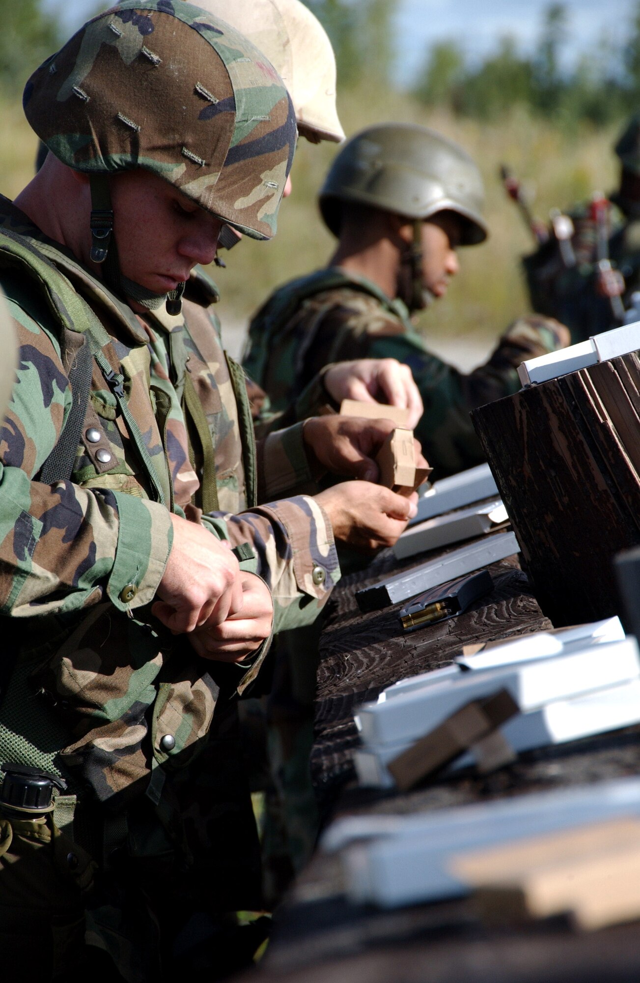 An Airman loads his M-16 clips with blanks during an exercise in combat skills training Aug. 3 at Eielson Air Force Base, Alaska. This training gives Airmen the skills necessary to perform and adapt in a combat environment. (U.S. Air Force photo/Airman 1st Class Christopher Griffin)