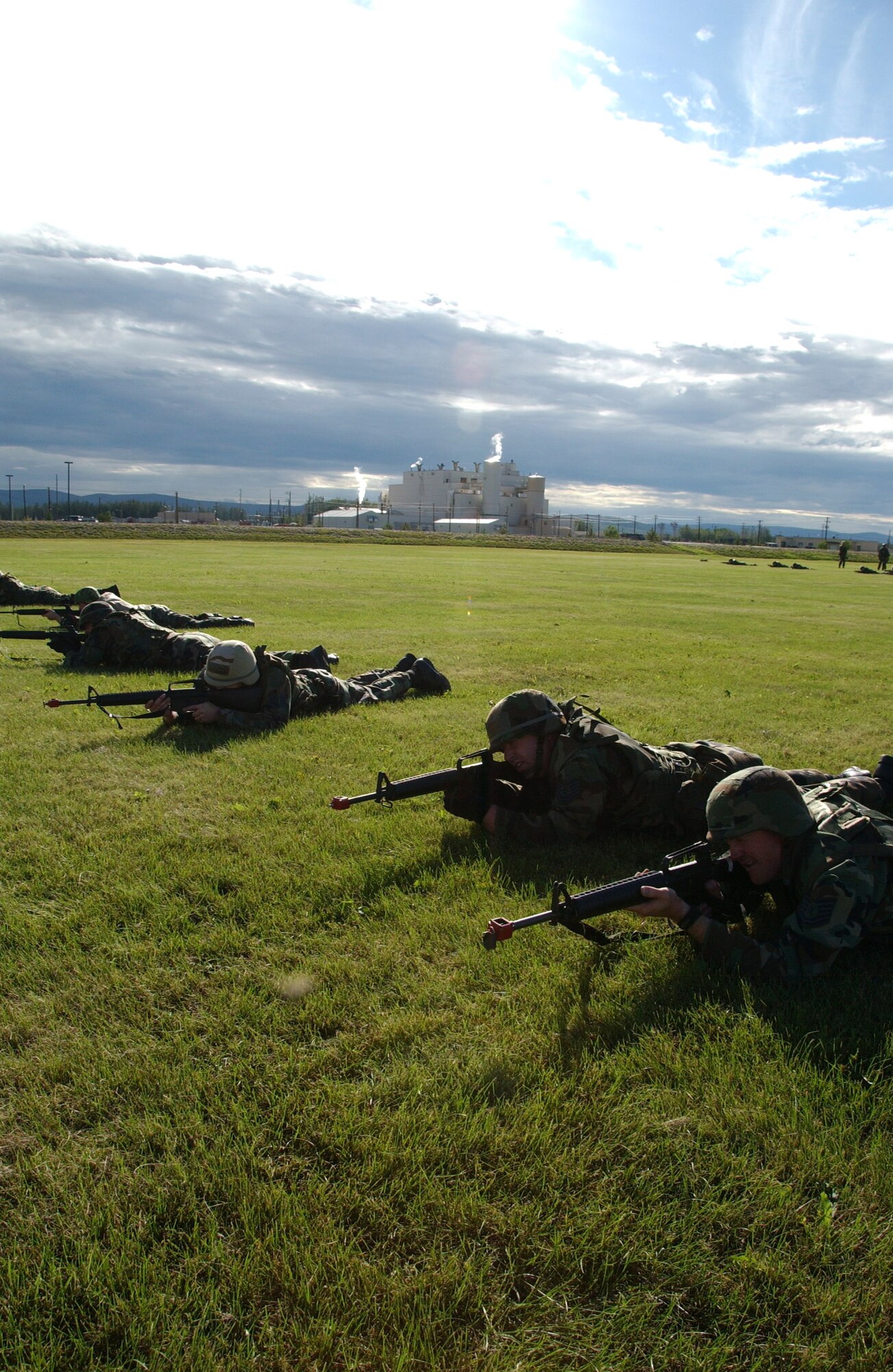 Airmen practice low-crawling as a part of combat skills training Aug. 3 at Eielson Air Force Base, Alaska. This training gives Airmen the necessary skills to perform and adapt in a combat environment while deployed to an overseas location. (U.S. Air Force photo/Airman 1st Class Christopher Griffin)