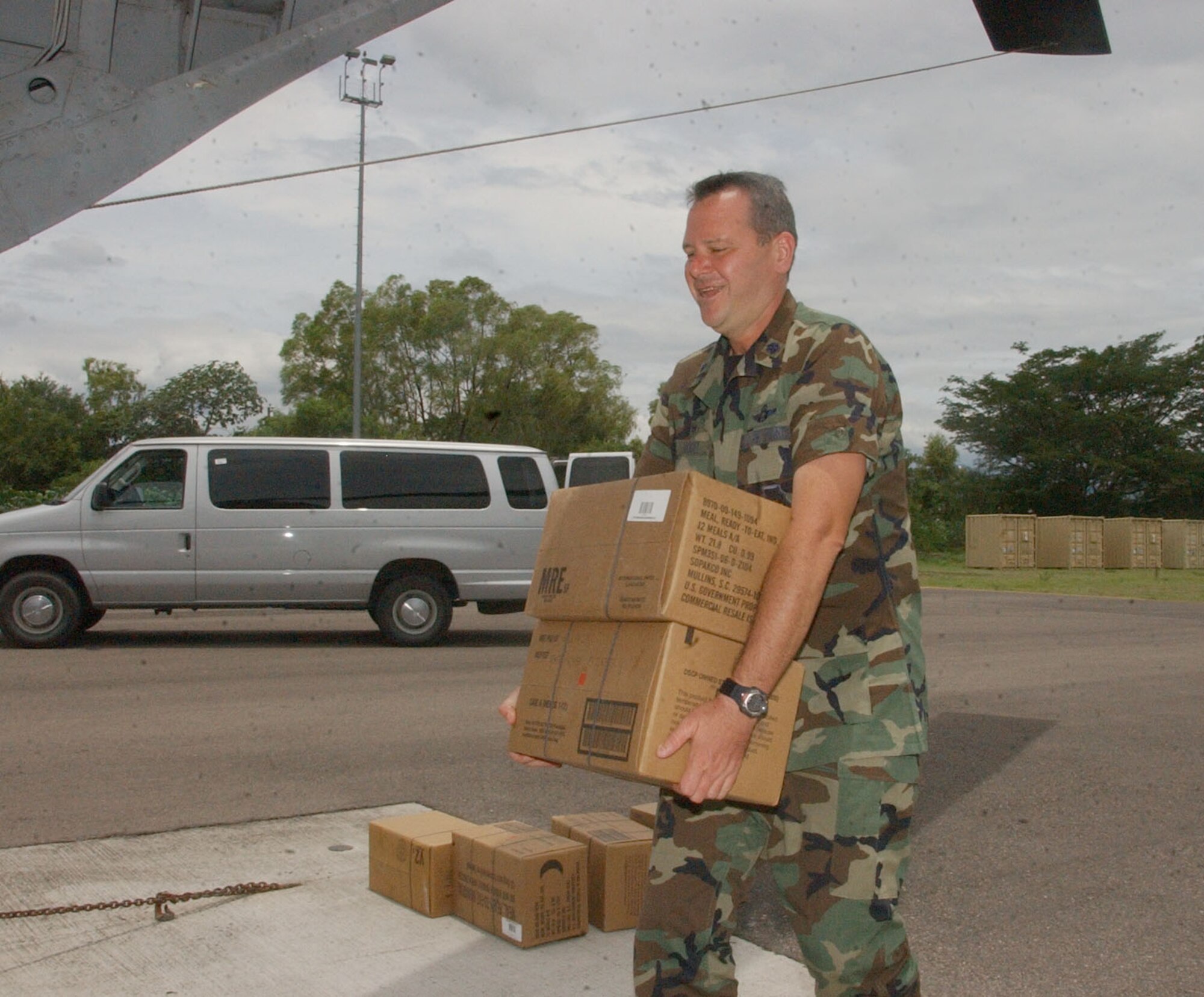 Air Force Lt. Col. Randall Vogel loads meals ready to eat onto a CH-47 Chinook helicopter Aug. 21 for troops deploying from Honduras.  Approximately 25 Airmen and Soldiers from Soto Cano Air Base left Honduras to assess the damage caused by Hurricane Dean in Belize and assist Belize in recovery efforts.  U.S. Air Force photo by Martin Chahin.