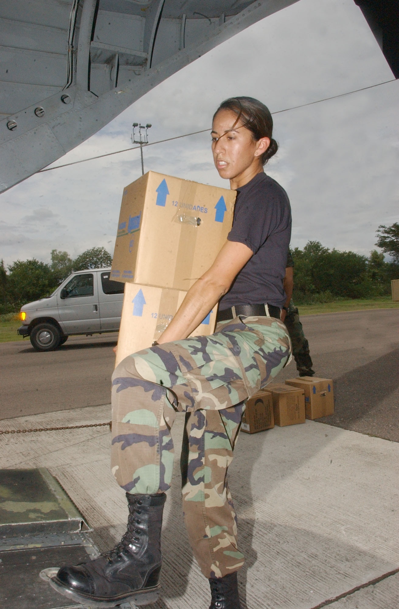 SOTO CANO AIR BASE, Honduras ? Air Force Capt. Kenya Colon loads water for deploying troops onto a CH-47 Chinook helicopter Aug. 21.  Approximately 25 Airmen and Soldiers from Soto Cano Air Base left Honduras to assess the damage caused by Hurricane Dean in Belize and assist Belize in recovery efforts.  U.S. Air Force photo by Martin Chahin.