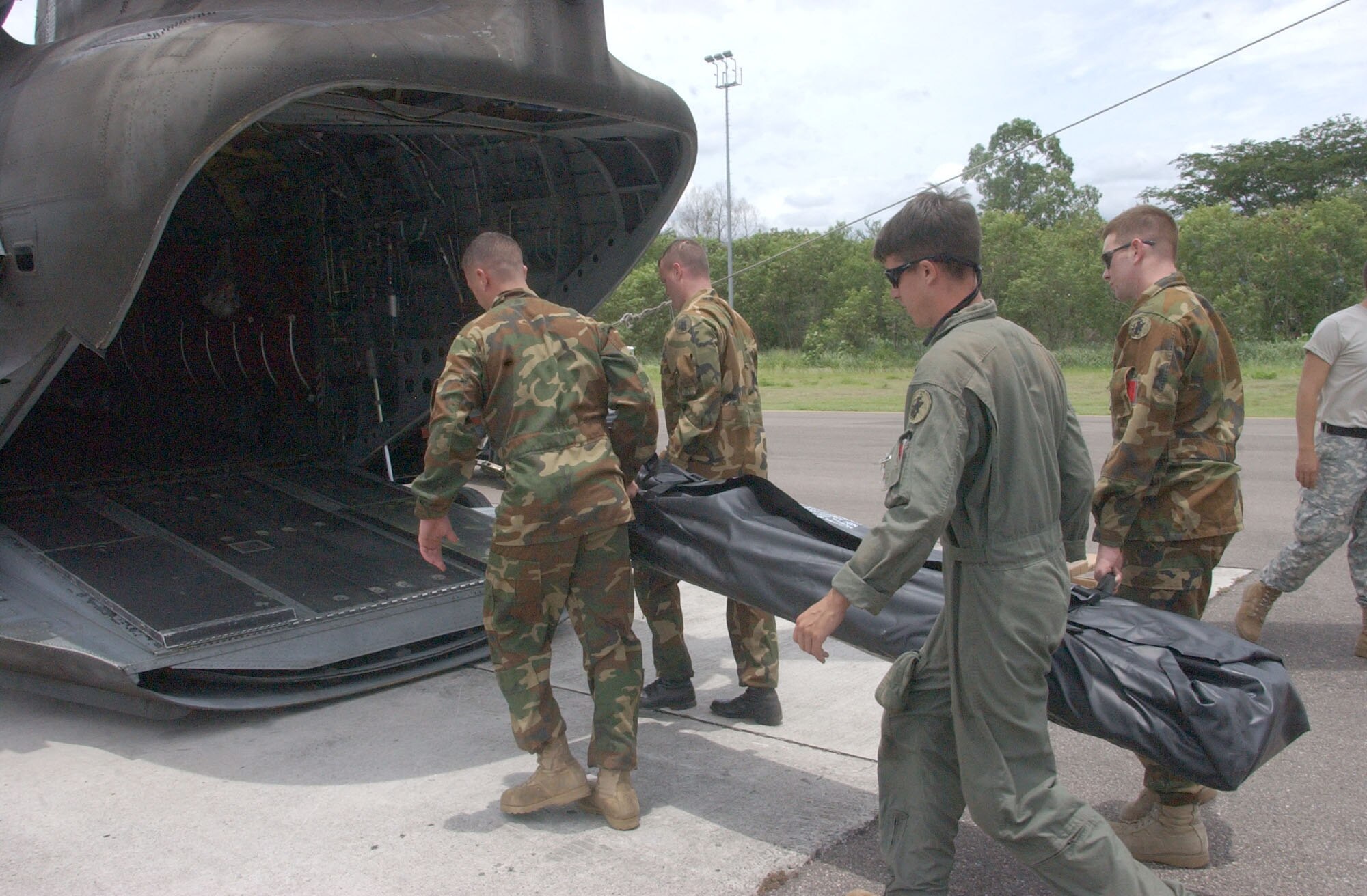 SOTO CANO AIR BASE, Honduras - Members of the 1st Battalion 228th Aviation Regiment here load equipment onto a CH-47 Chinook helicopter Aug. 21.  Approximately 25 Airmen and Soldiers from Soto Cano Air Base left Honduras to assess the damage caused by Hurricane Dean in Belize and assist Belize in recovery efforts.  U.S. Air Force photo by Martin Chahin.