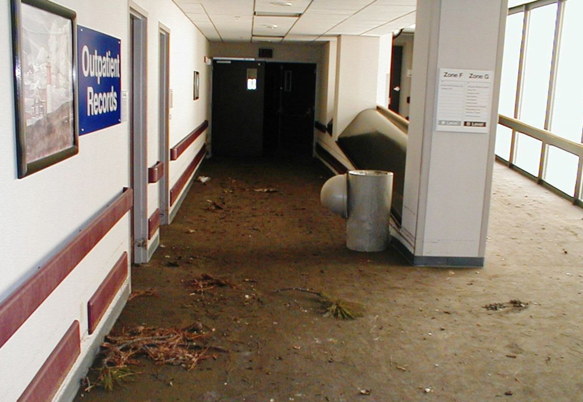 The medical center’s basement corridor near the former outpatient records location is covered with debris immediately after Keesler’s storm surge receded.  More than 100,000 medical records were saved by the medical staff at the height of the storm.  (U.S. Air Force photo by Sgt. Jeffrey Gatton) 