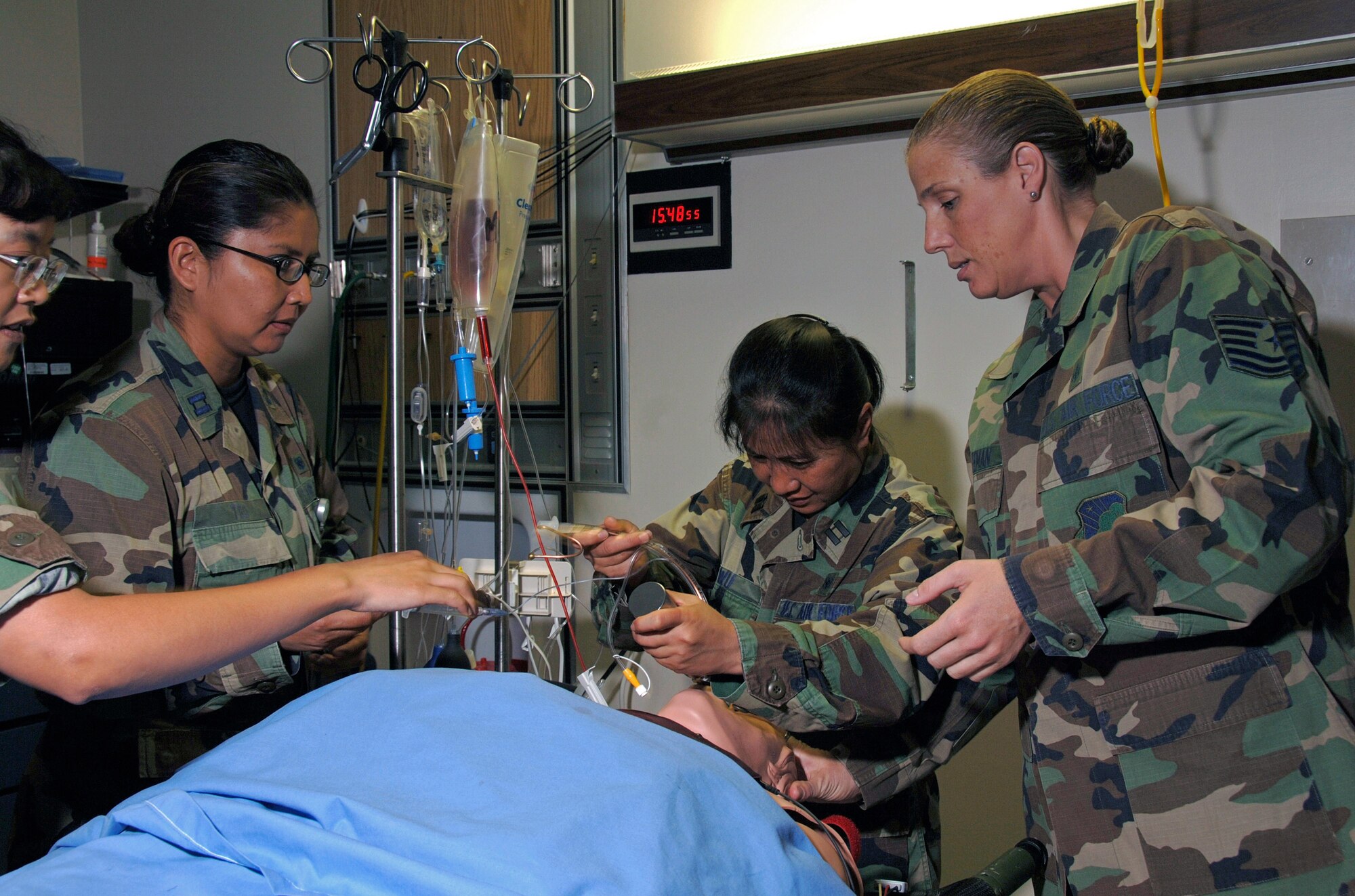 Capt. Yun Wu (center) practices patient intubation on a simulation mannequin Aug. 13, assisted by Tech. Sgt. Tammy Freeman and Capt. Lenora Tso during a trauma and pre-deployment training course at Wilford Hall Medical Center at Lackland Air Force Base, Texas. Medical technicians and nurses participated in the trauma and pre-deployment course in preparation for deployments to Iraqi and Afghanistan. Captains Wu and Tso are clinical nurses and Sergeant Freeman is a medical technician.  They are assigned to the 59th Medical Wing. (U.S. Air Force photo/Master Sgt. Kimberly A. Yearyean-Siers)