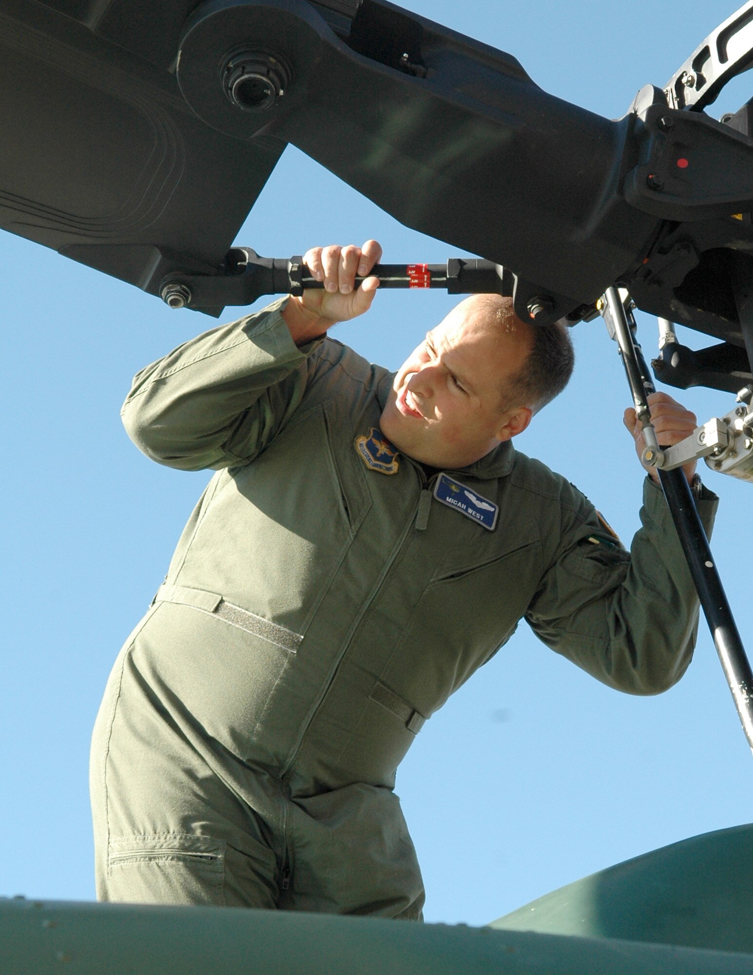 FAIRCHILD AIR FORCE BASE, Wash. – Capt. Micah West, 36th Rescue Flight UH-1N Huey pilot is on top of the aircraft inspecting the rotors during pre-flight checks. The pilot assists the flight engineer with pre-flight checks, while the FE is inspecting the hoist prior to a mission. The pilot is up top looking for anything out of the ordinary that may cause the aircraft to fly incorrectly, or could possible cause a problem. (U.S. Air Force Photo / Tech. Sgt. Larry W. Carpenter Jr.)