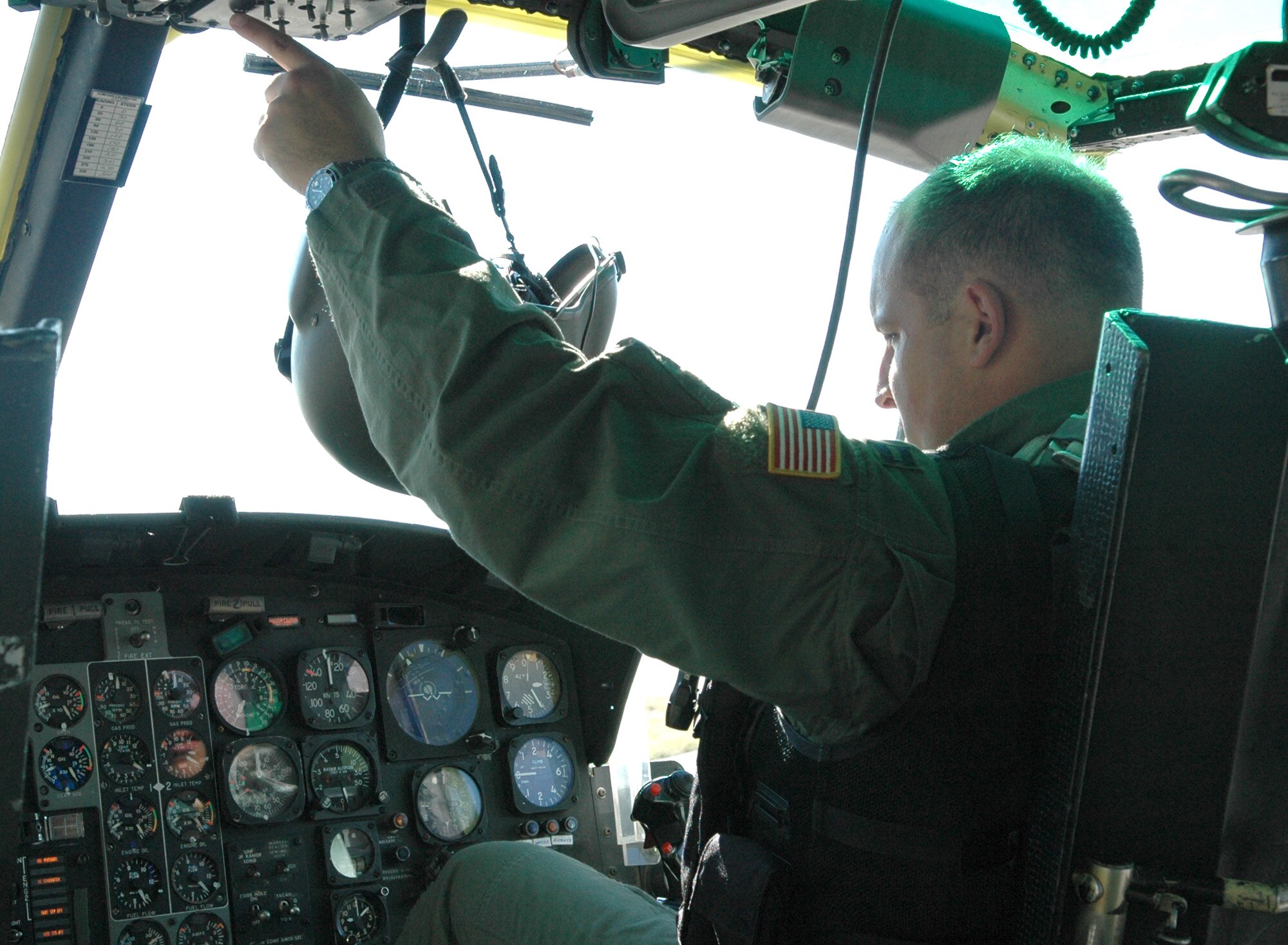FAIRCHILD AIR FORCE BASE, Wash. -- Capt. Micah West, 36th Rescue Flight UH-1N Huey pilot, begins flipping switches ensuring the helicopter is ready for take-off.  During this process, every switch that is flipped will be verified by the flight engineer or pilot/co-pilot to ensure the right switches are being used. This is more crucial when the aircraft is in flight because flipping the wrong switch could possibly bring down the helicopter. (U.S. Air Force Photo / Tech. Sgt. Larry W. Carpenter Jr.)